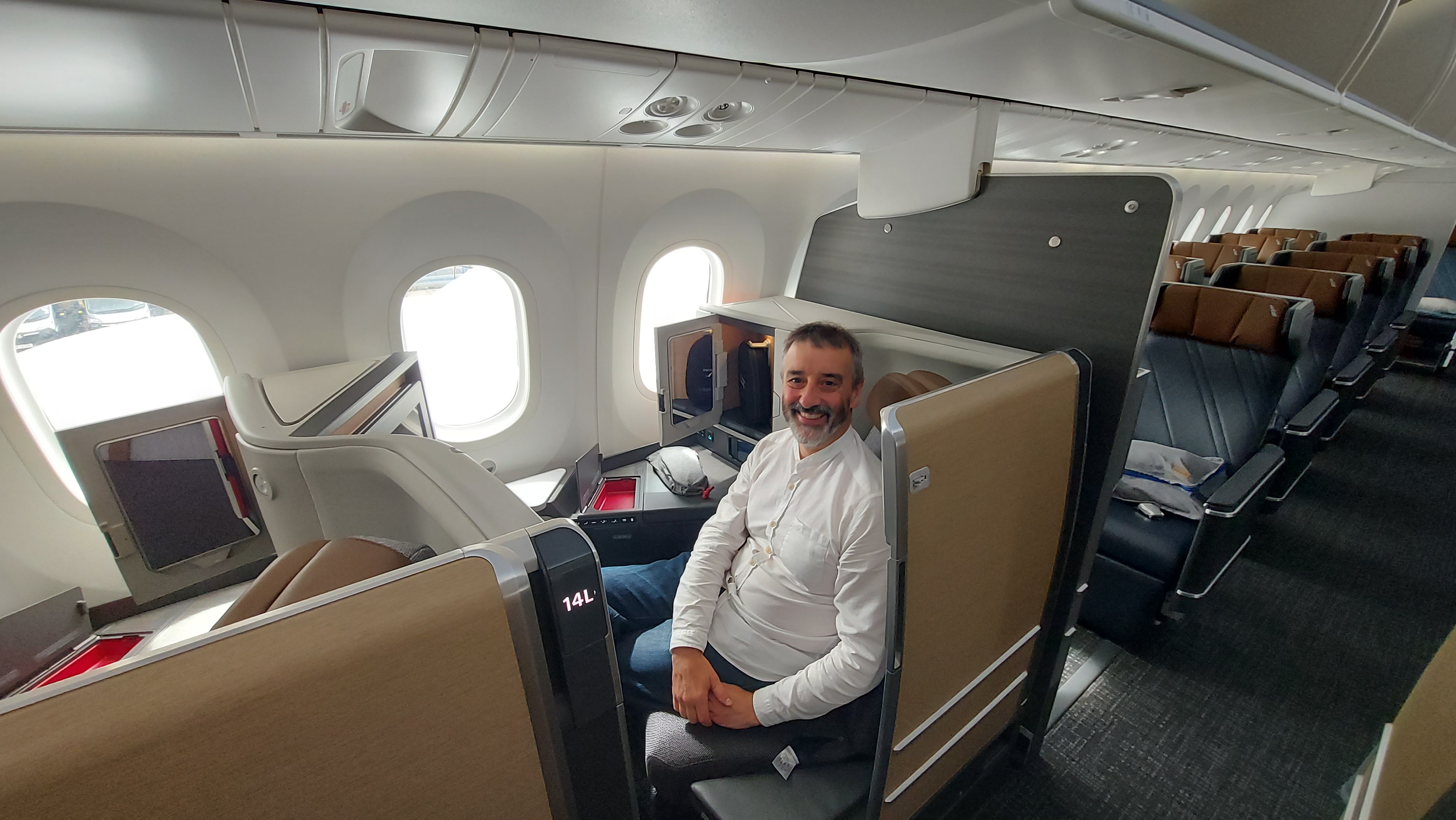 Ted boards a four-week-old American Airlines Dreamliner at London's Heathrow Airport. Ted is pictured above in the new Flagship Suite business-class seat