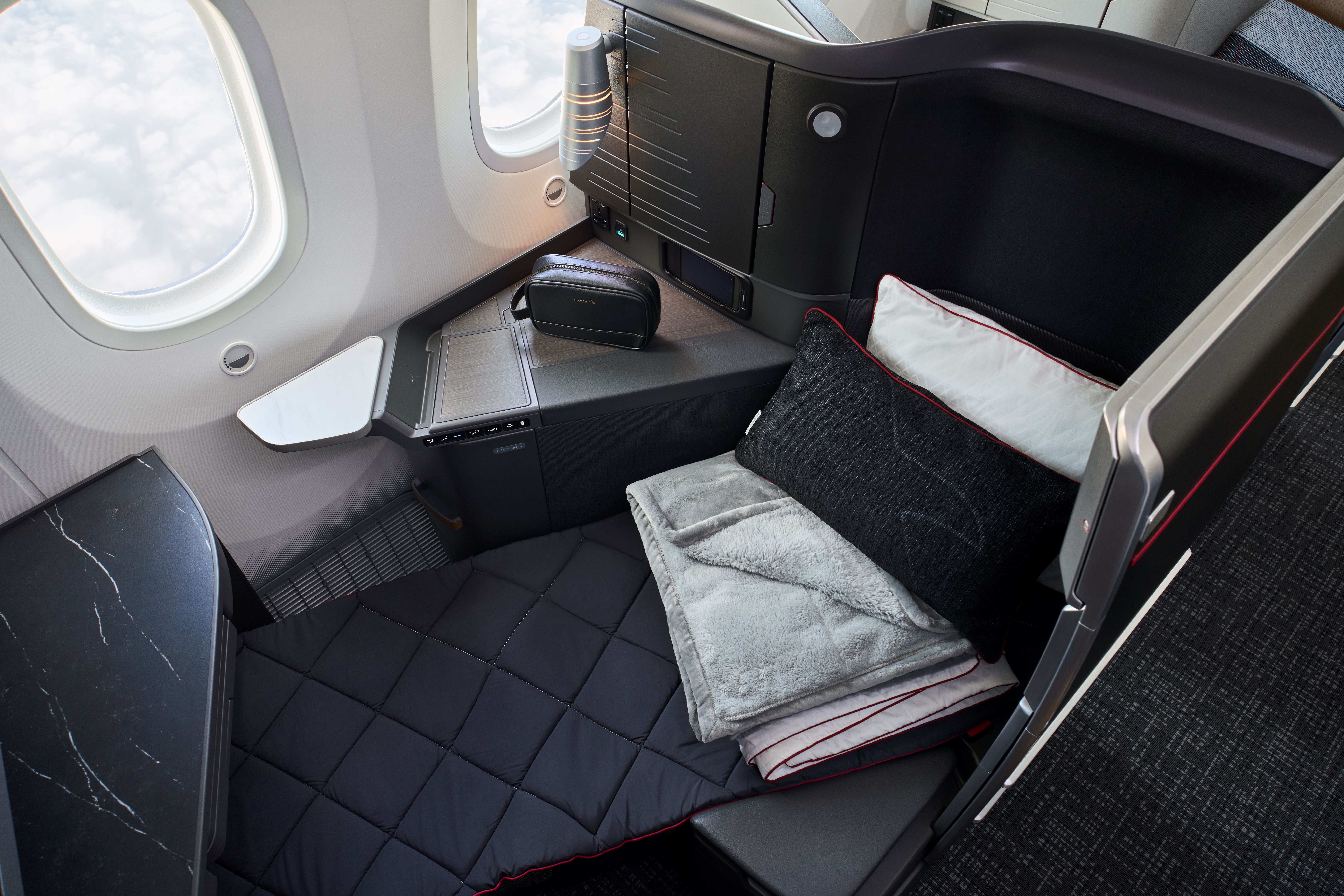 There are eight Flagship Suite Preferred seats, pictured, at the front of the aircraft. These are supersized versions of the regular lie-flat business-class seats