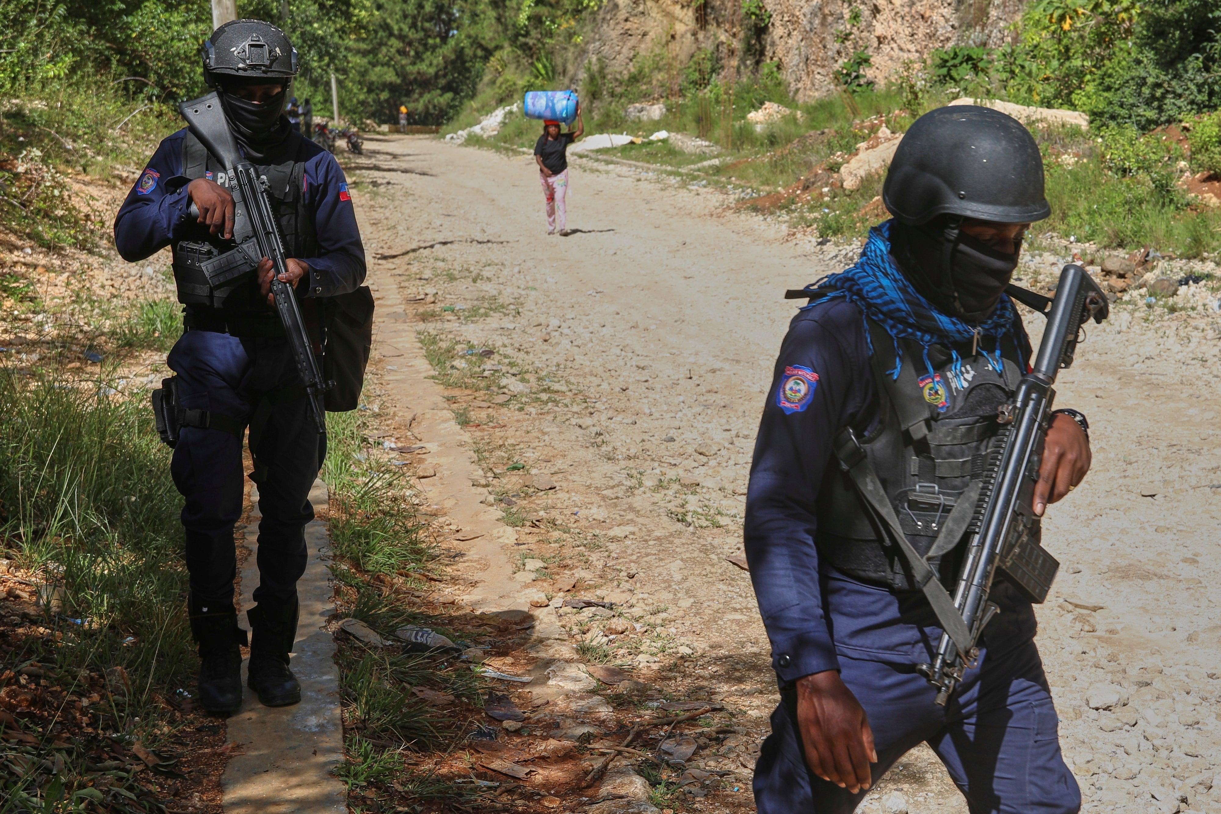 Police officers patrol the area near the Saint-Hélène orphanage in the Kenscoff neighborhood of Port-au-Prince, Haiti