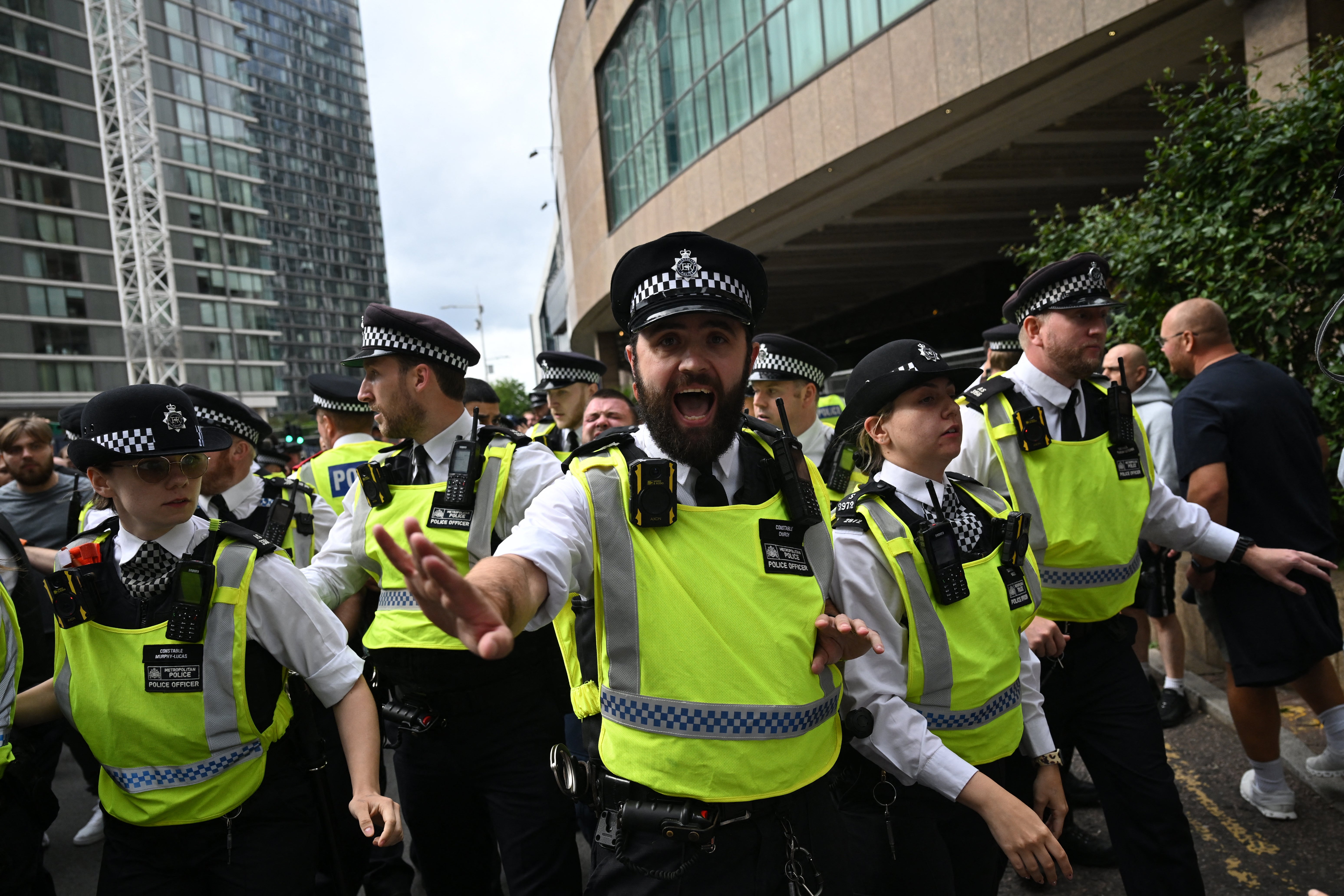 Police respond to the protest outside a hotel in Canary Wharf used to house asylum seekers on Sunday