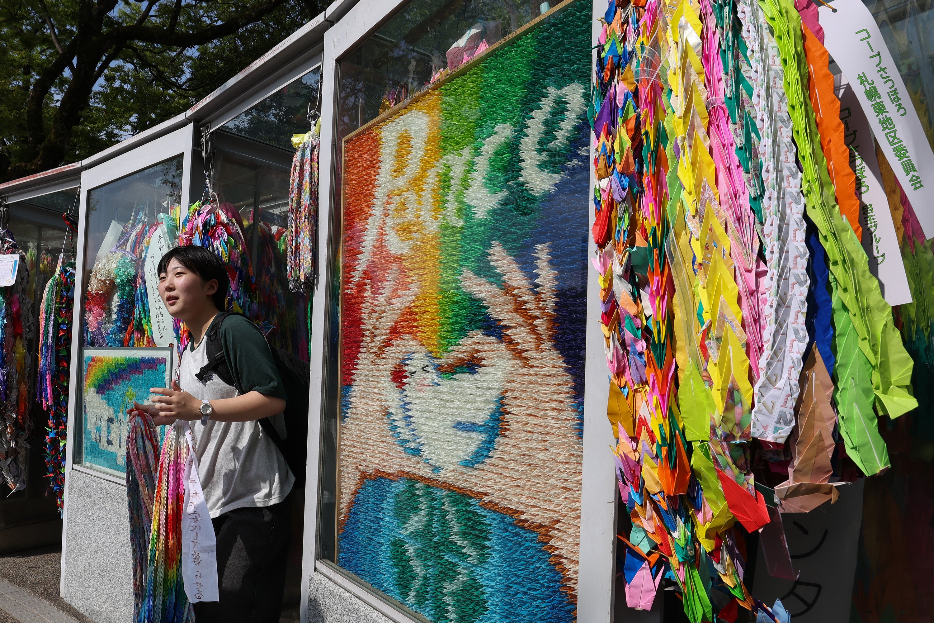 A young girl visits the Children’s Peace Monument at the Hiroshima Peace Memorial Park