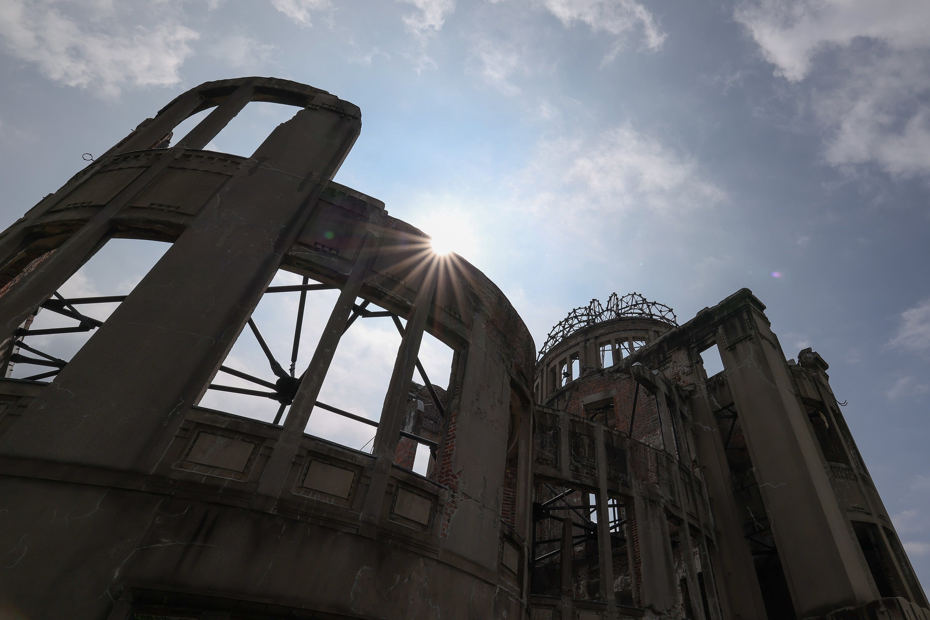 The sun rises above the Atomic Bomb Dome