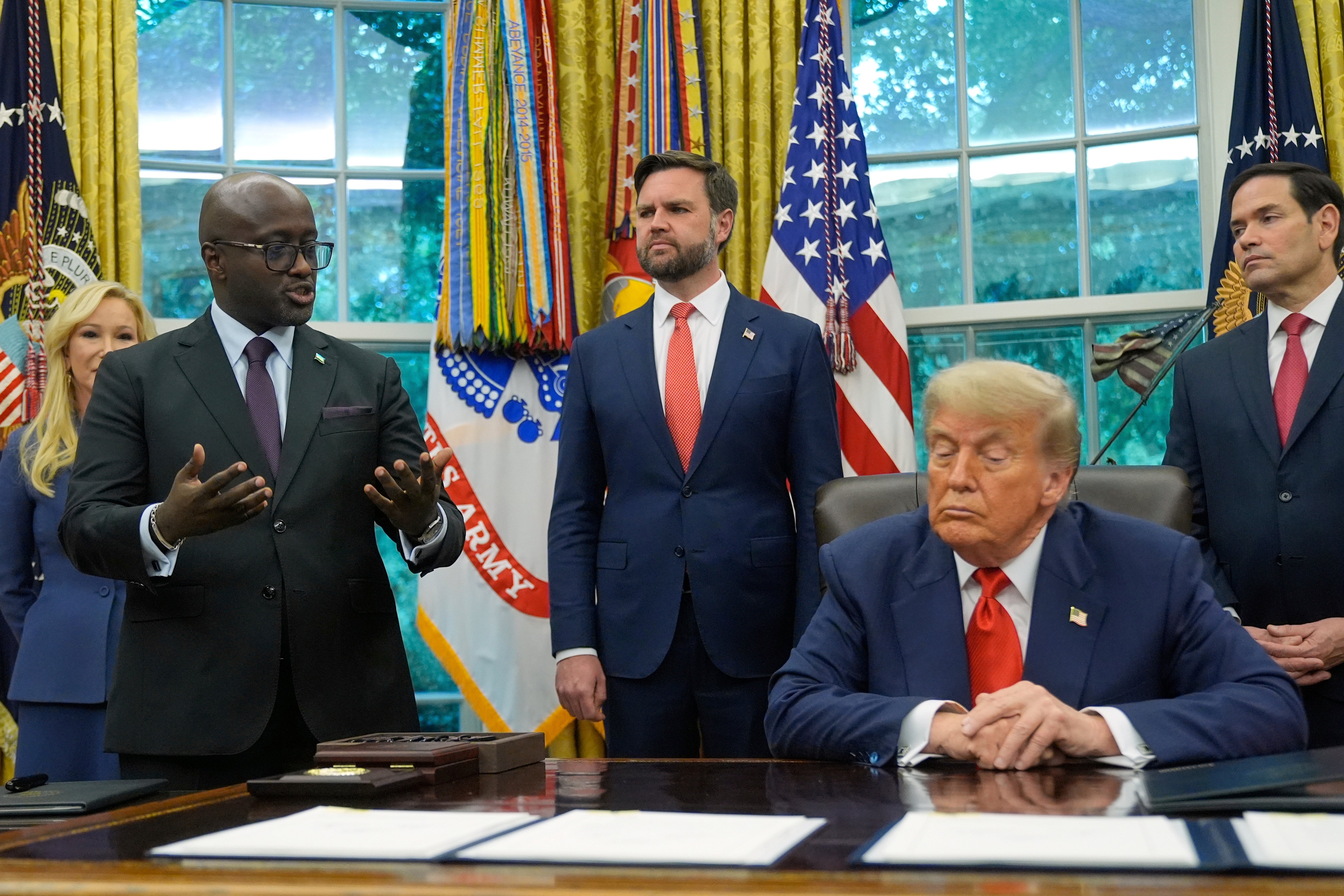 Trump listens as Rwanda's Foreign Minister Olivier Nduhungirehe speaks during an event with Congo's Foreign Minister Therese Kayikwamba Wagner in June at the White House