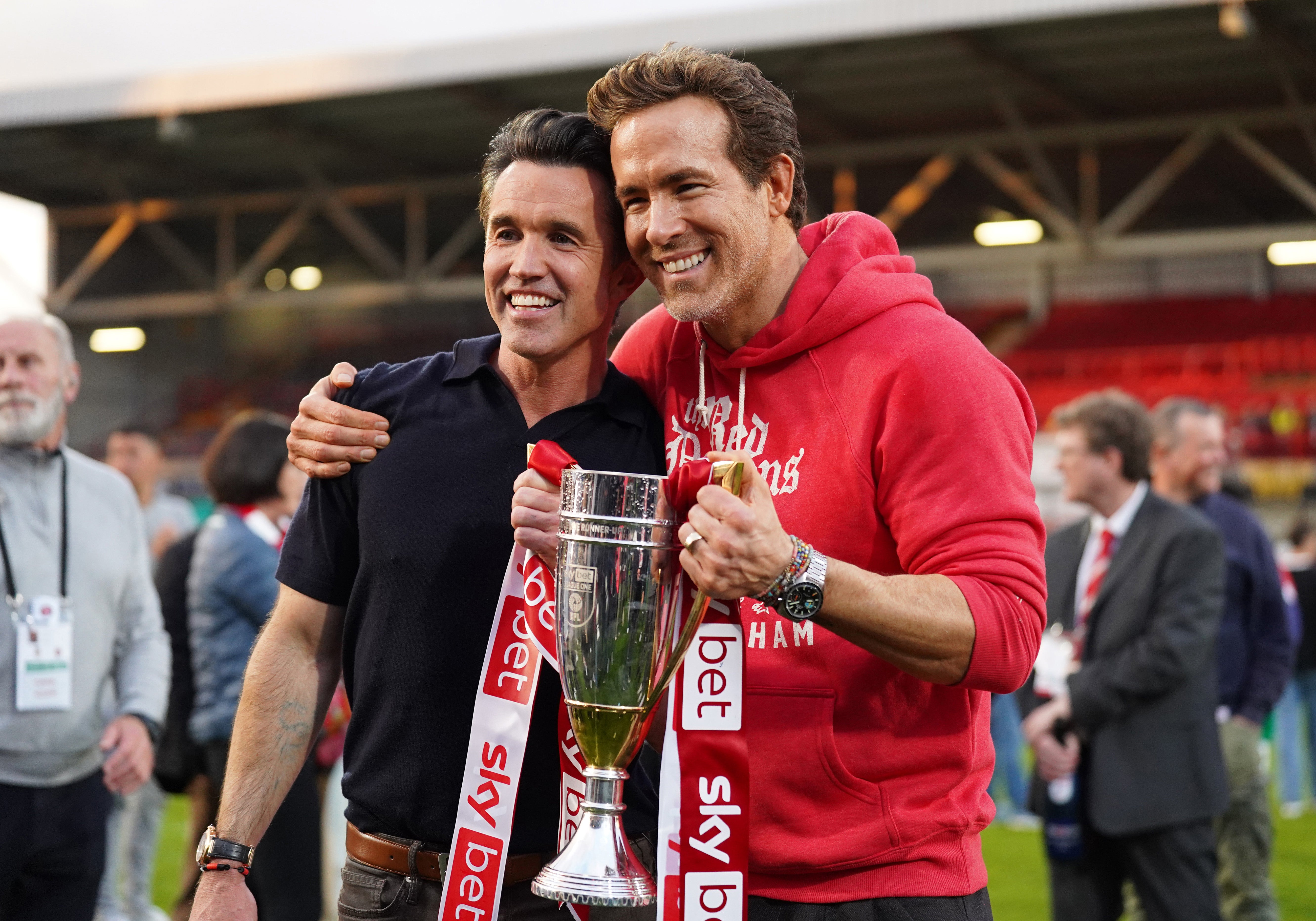 Rob McElhenney and Ryan Reynolds, co-owners of Wrexham, pose with the trophy in April, following the club’s promotion to the Sky Bet Championship