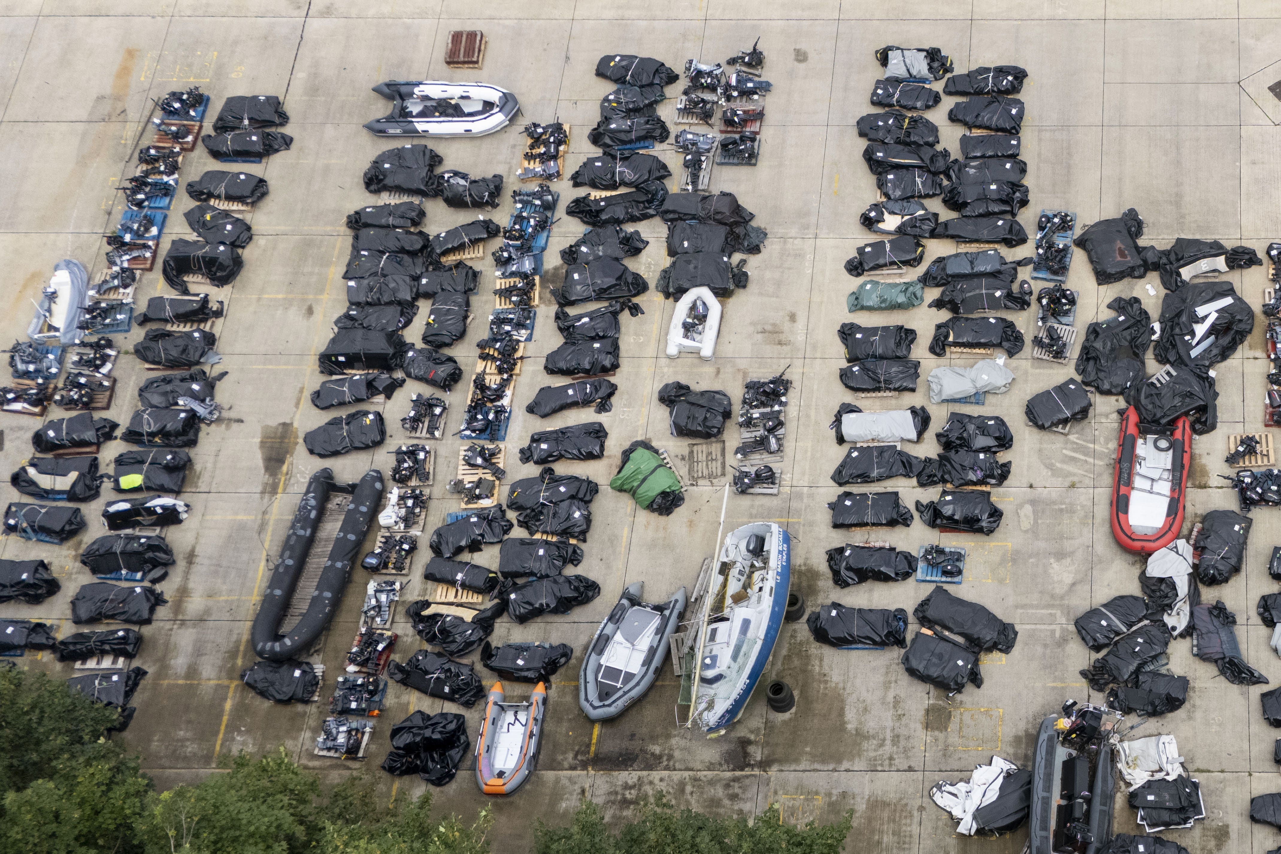 Small boats and outboard motors used by people thought to be migrants to cross the Channel from France at a storage facility in Dover, Kent (Gareth Fuller/PA)