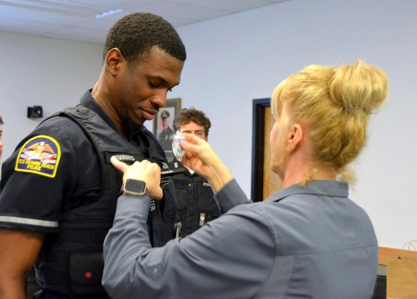 Officer Jon Luke Evans receives his police badge. DHS’s E-Verify system verified he was authorized to work in the U.S., the Old Orchard Beach Police Department said, while DHS says the police department had a ‘reckless reliance’ on the system