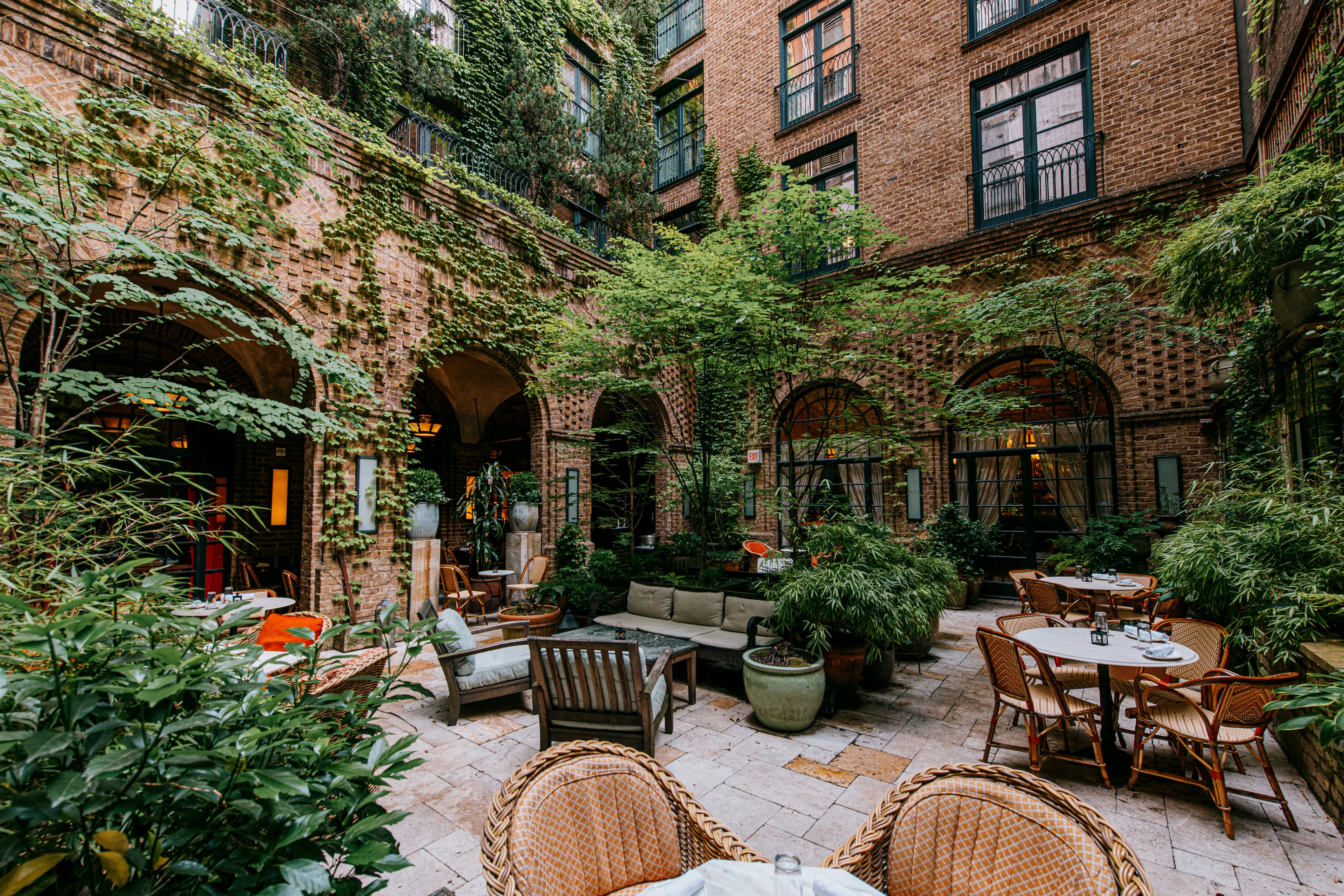 The courtyard with greenery spilling down the exterior of the hotel is a wonderful space to relax
