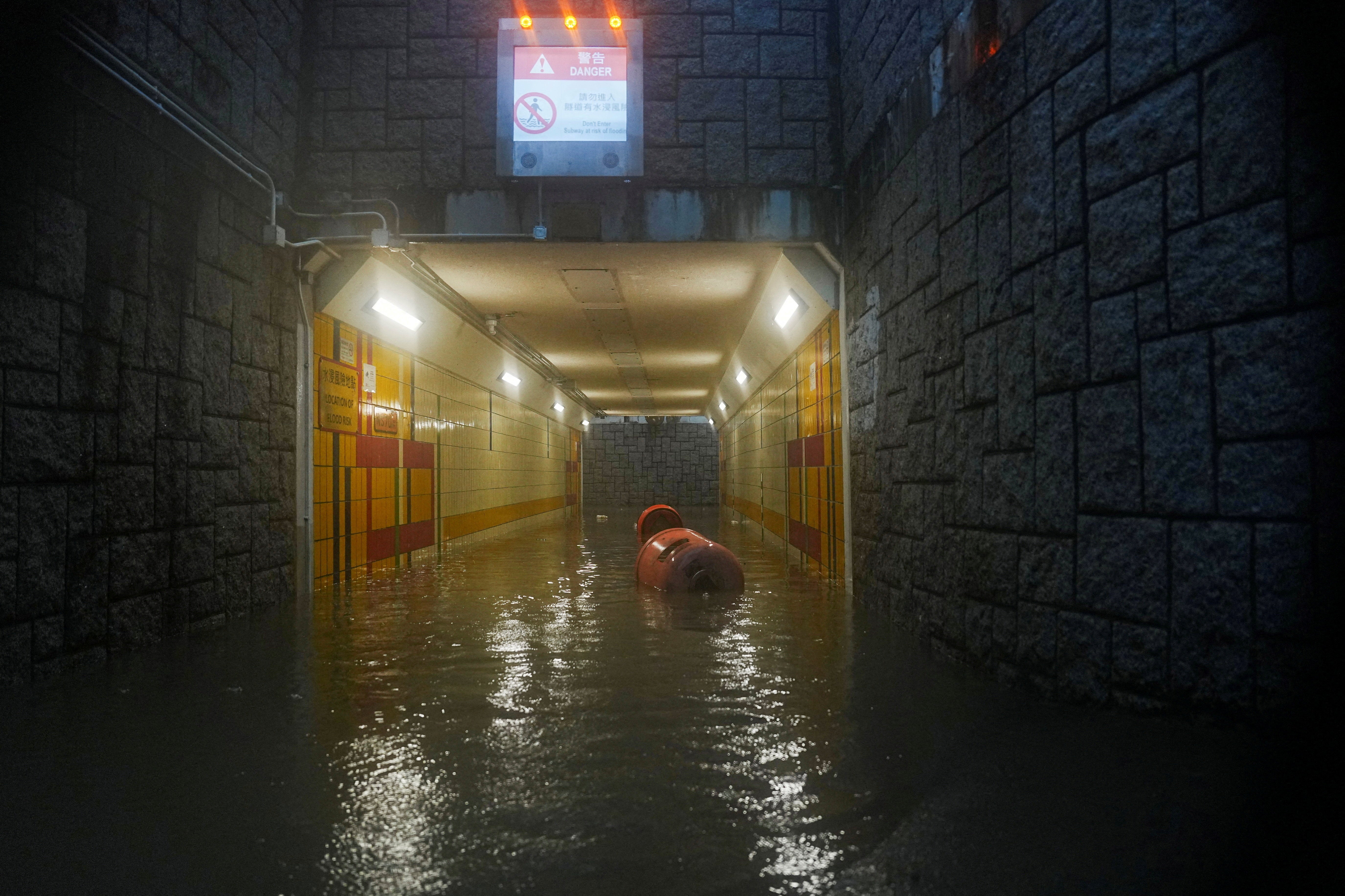 A pedestrian tunnel is partially submerged during heavy rains in Hong Kong on 5 August 2025
