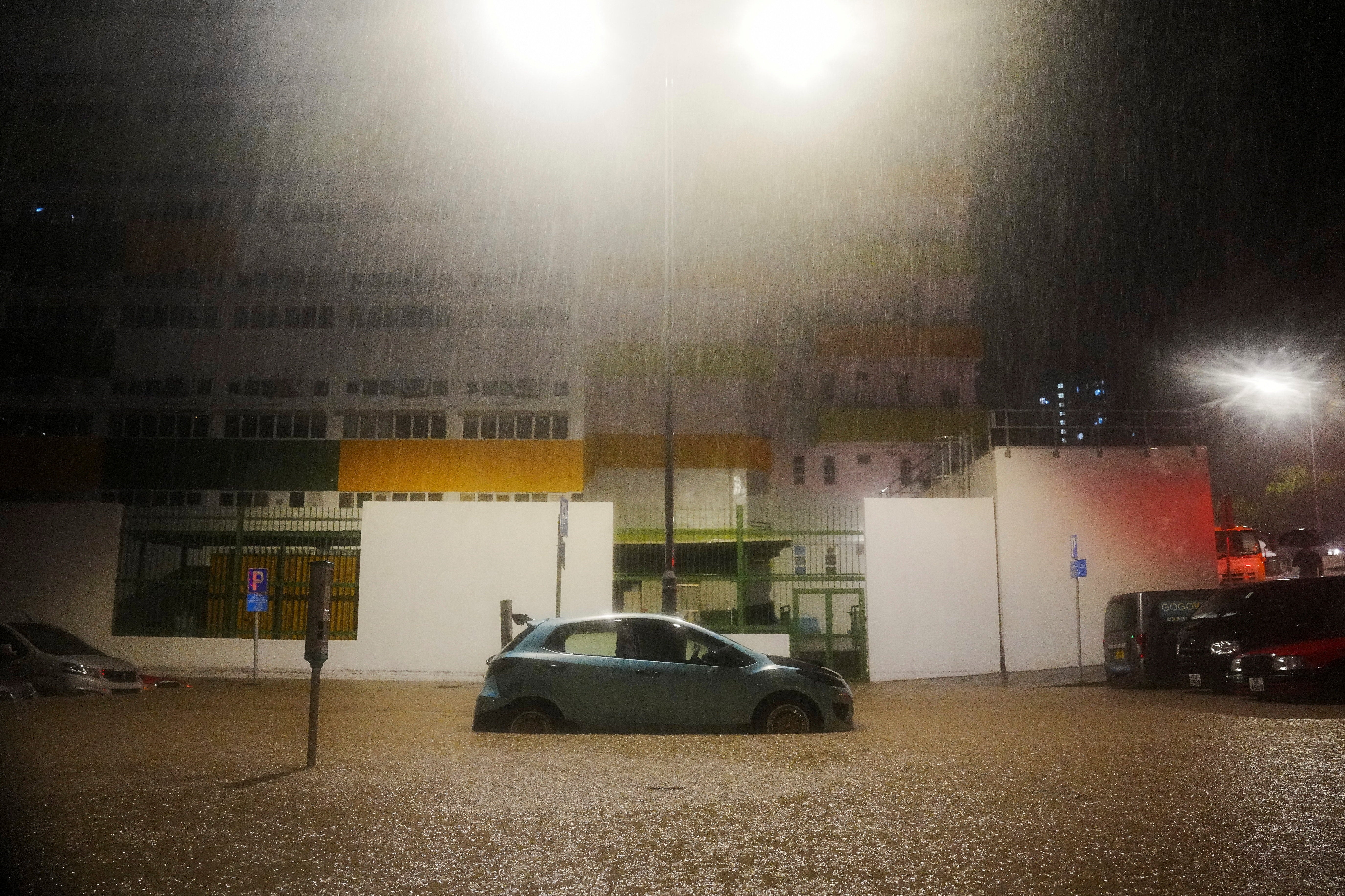 Vehicles are partially submerged during heavy rains in Hong Kong on 5 August 2025