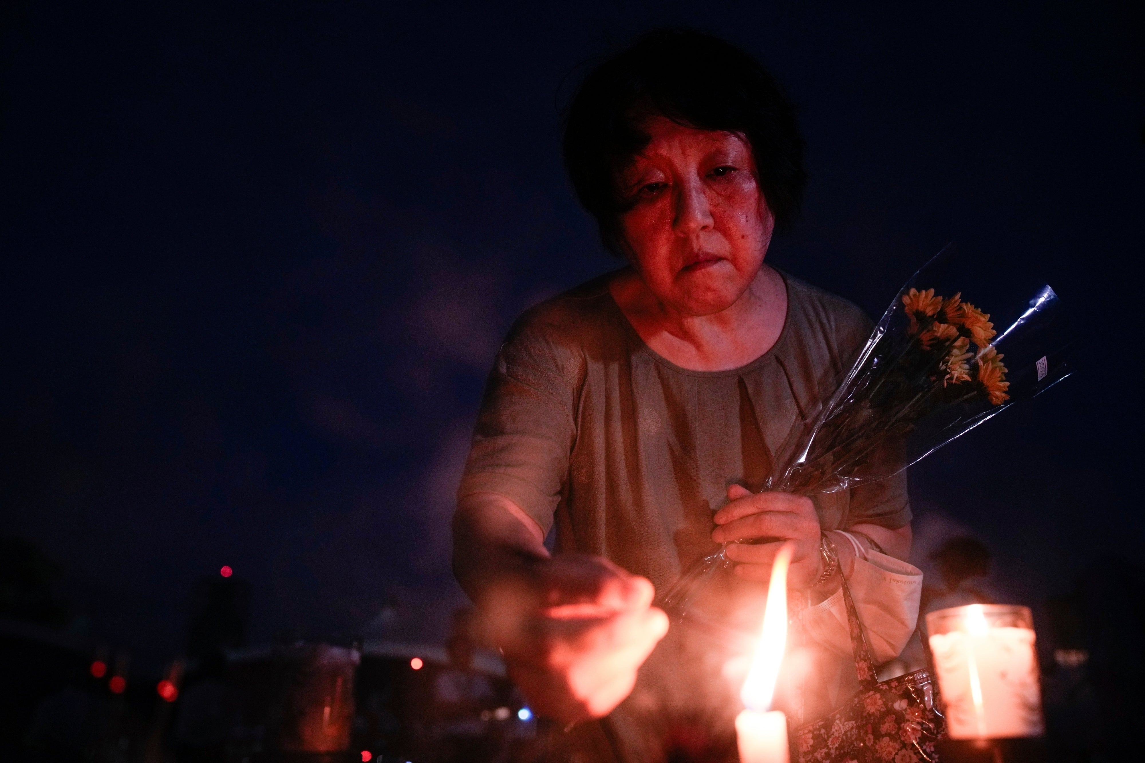 A visitor lights incense sticks at the Peace Memorial Park in Hiroshima ahead of the anniversary commemorations