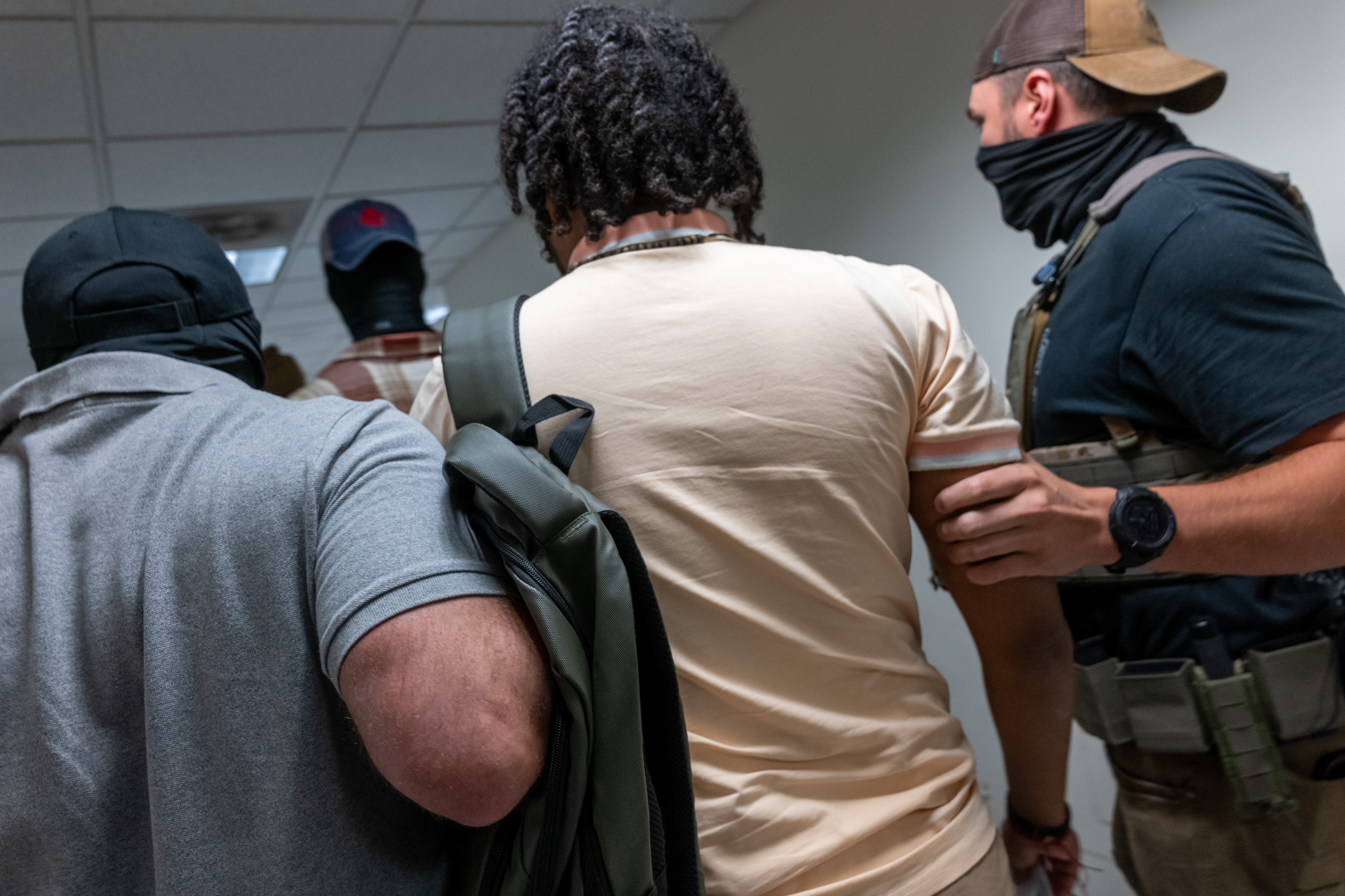 Federal agents detain a man as they patrol the halls of immigration court at the Jacob K Javitz Federal Building in New York City on August 5 2025