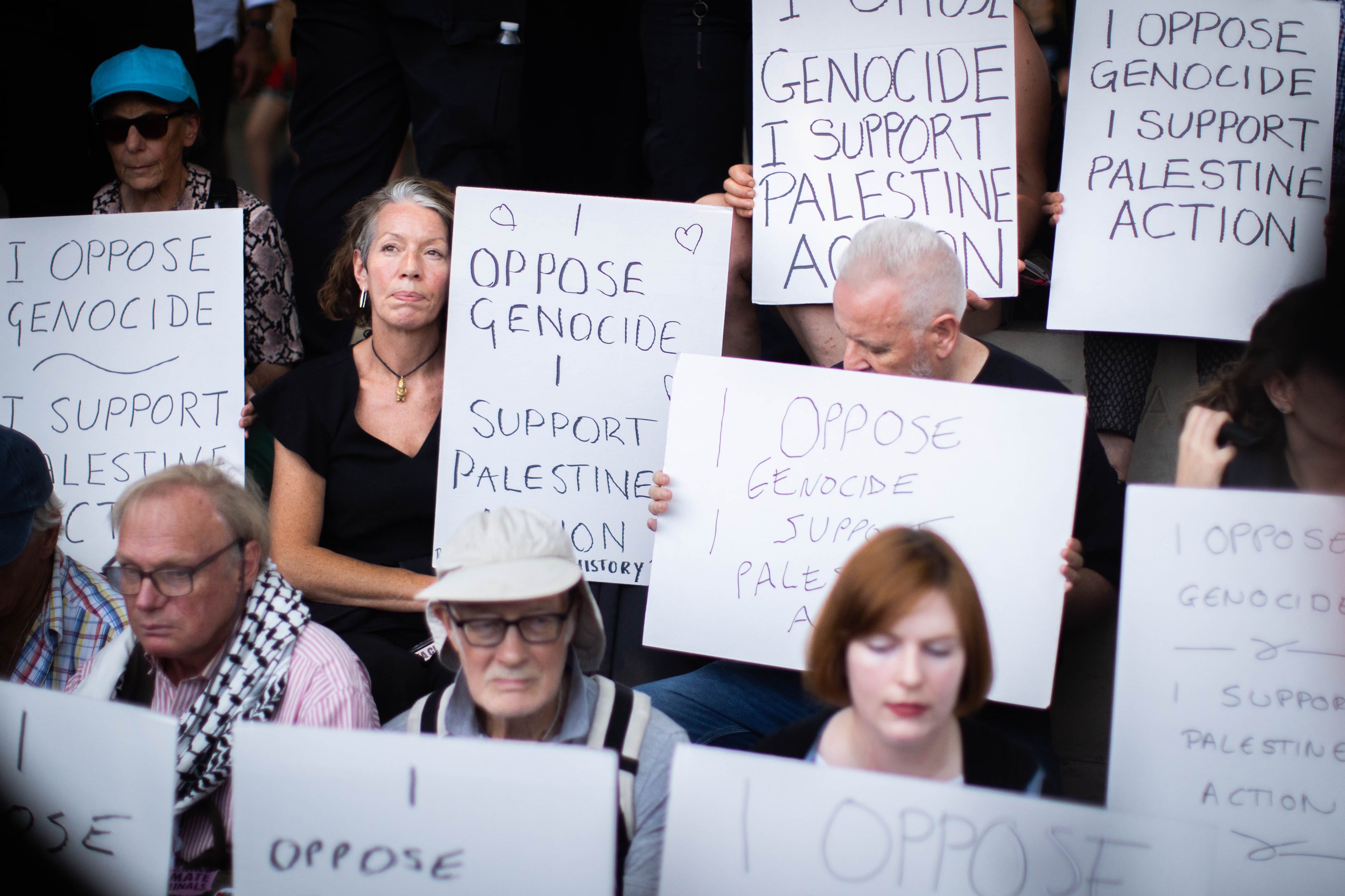 People take part in a protest in Parliament Square, London, to call for de-proscription of Palestine Action (James Manning/PA)