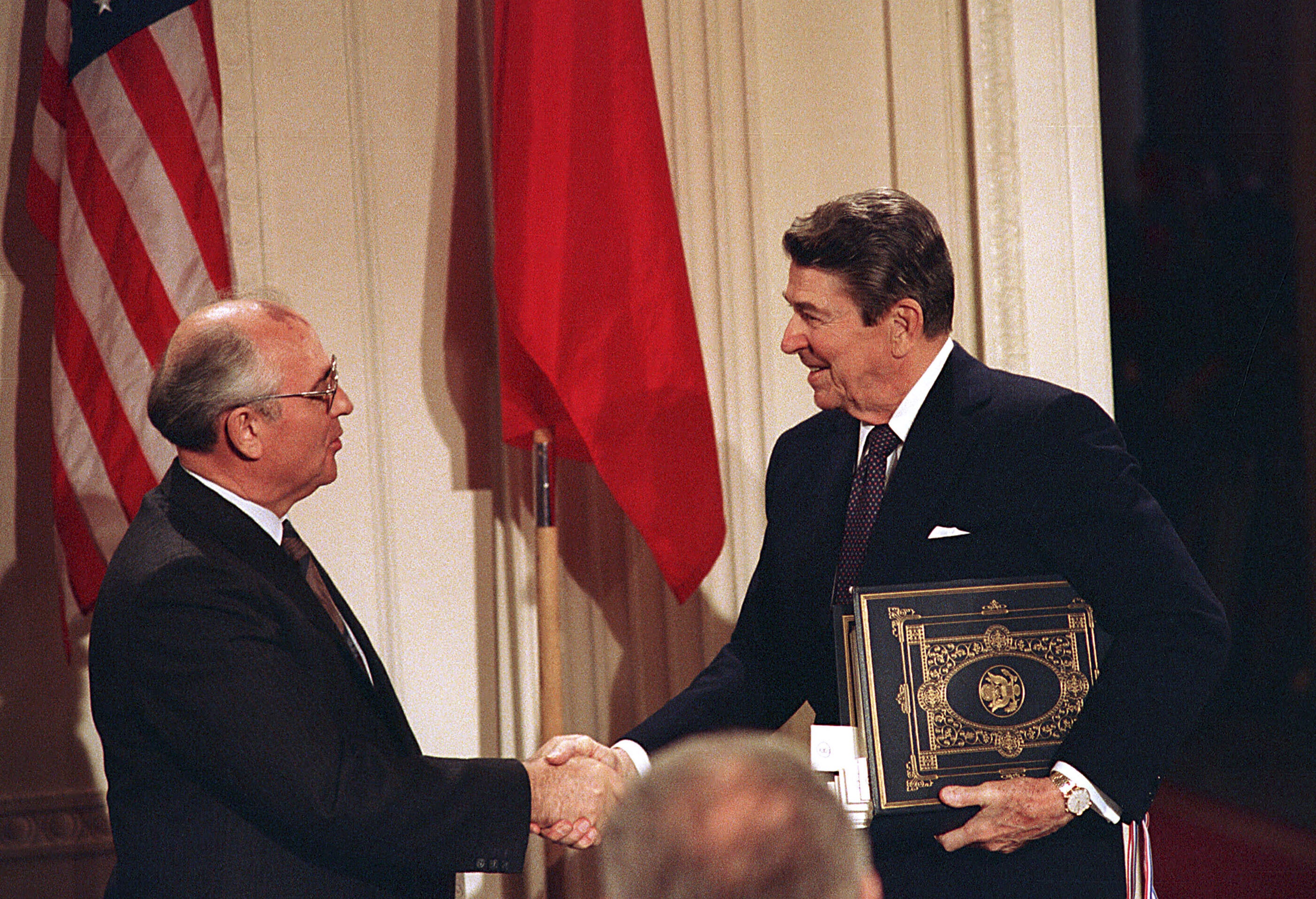 U.S. President Ronald Reagan, right, shakes hands with Soviet leader Mikhail Gorbachev after the two leaders signed the Intermediate Range Nuclear Forces Treaty