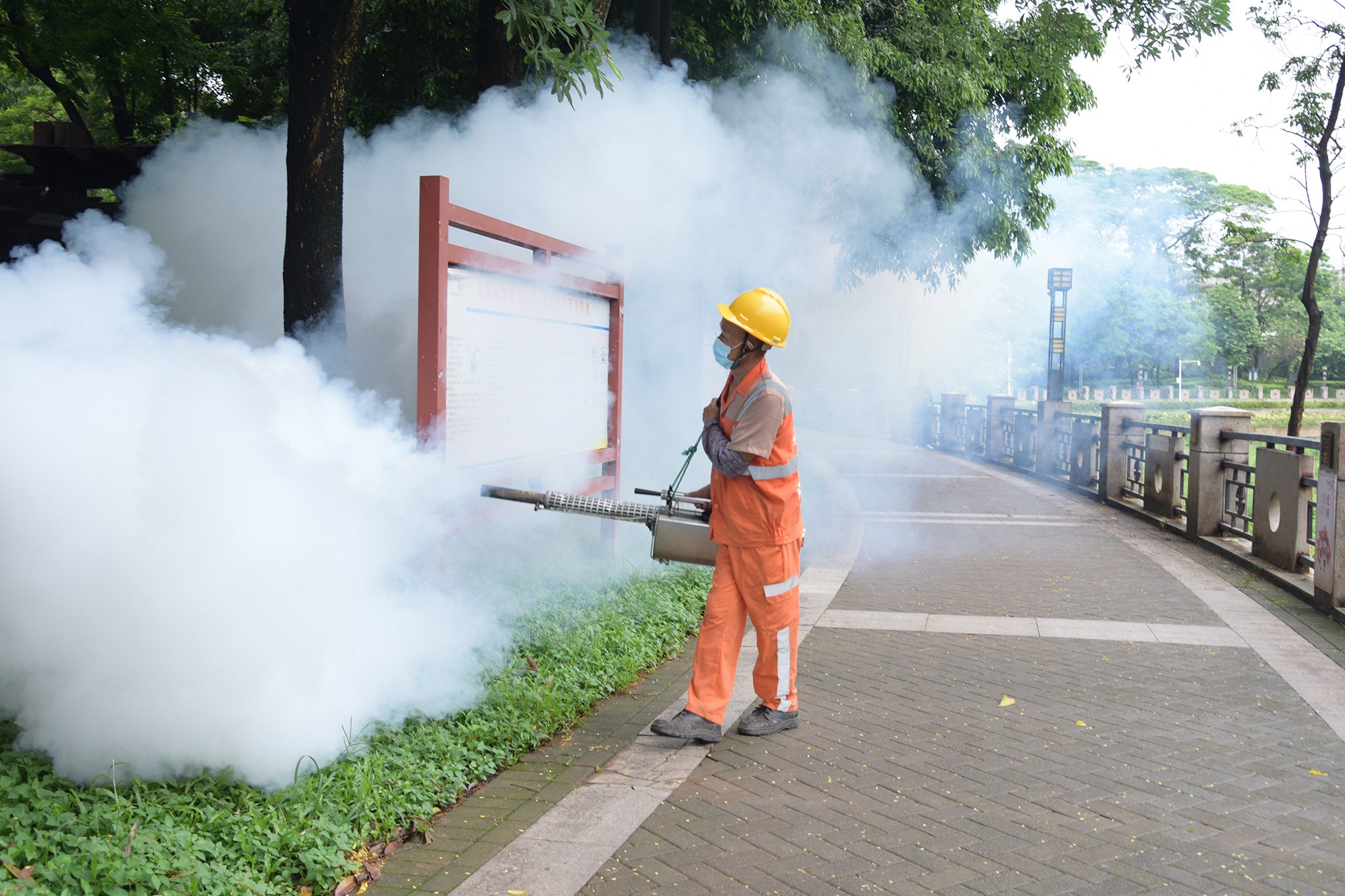 A worker attempts to control the spread of disease in Dongguan, China