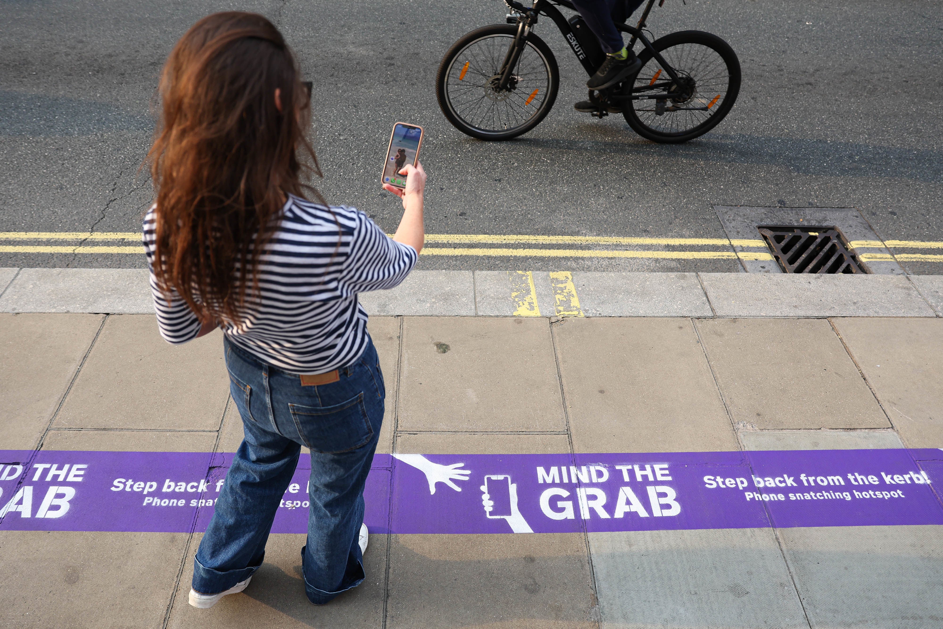 ‘Mind the Grab’ phone theft warnings have been painted on London streets