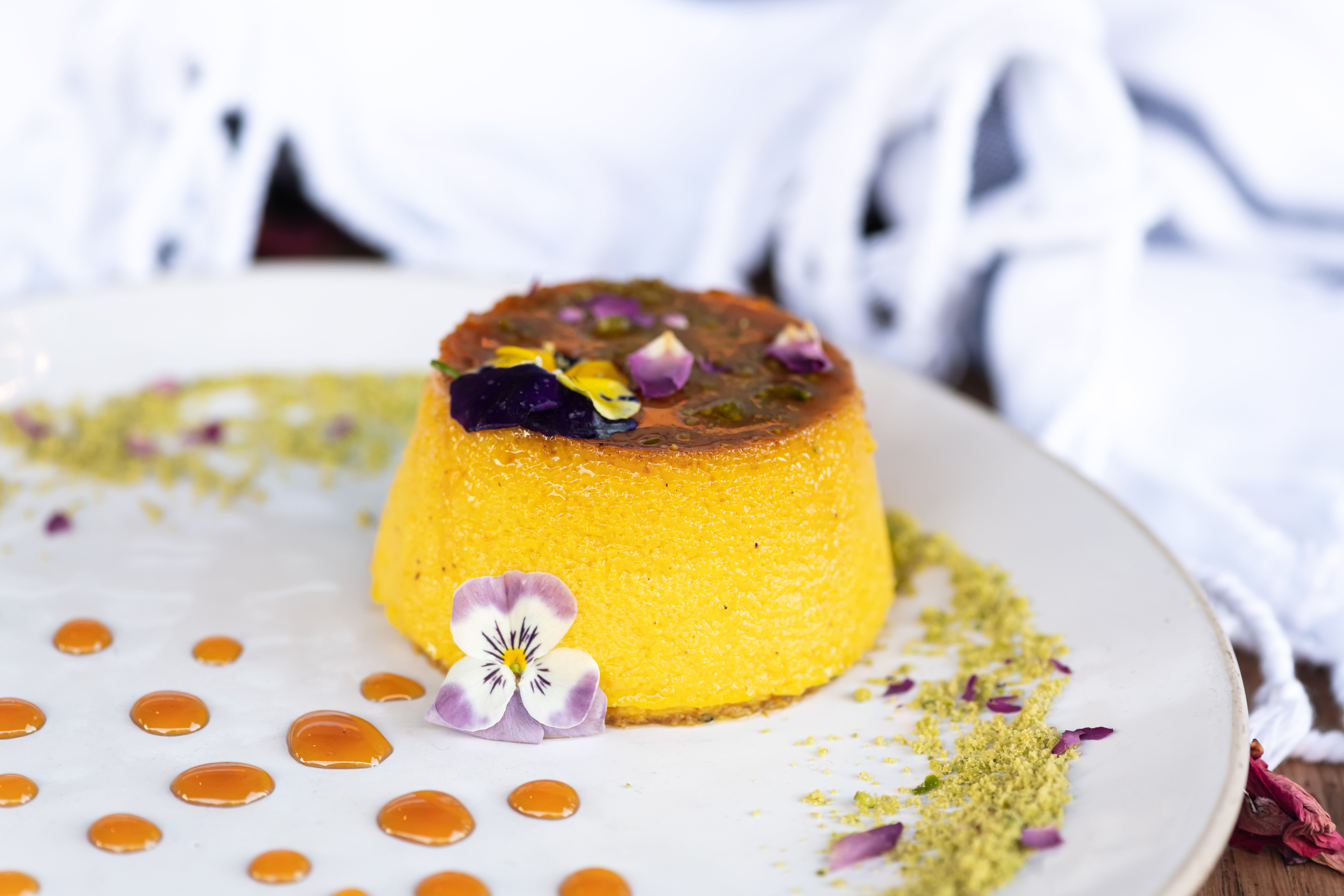 Delicately infused with saffron, rose water and cardamom, this silky custard sets over a glossy layer of caramel