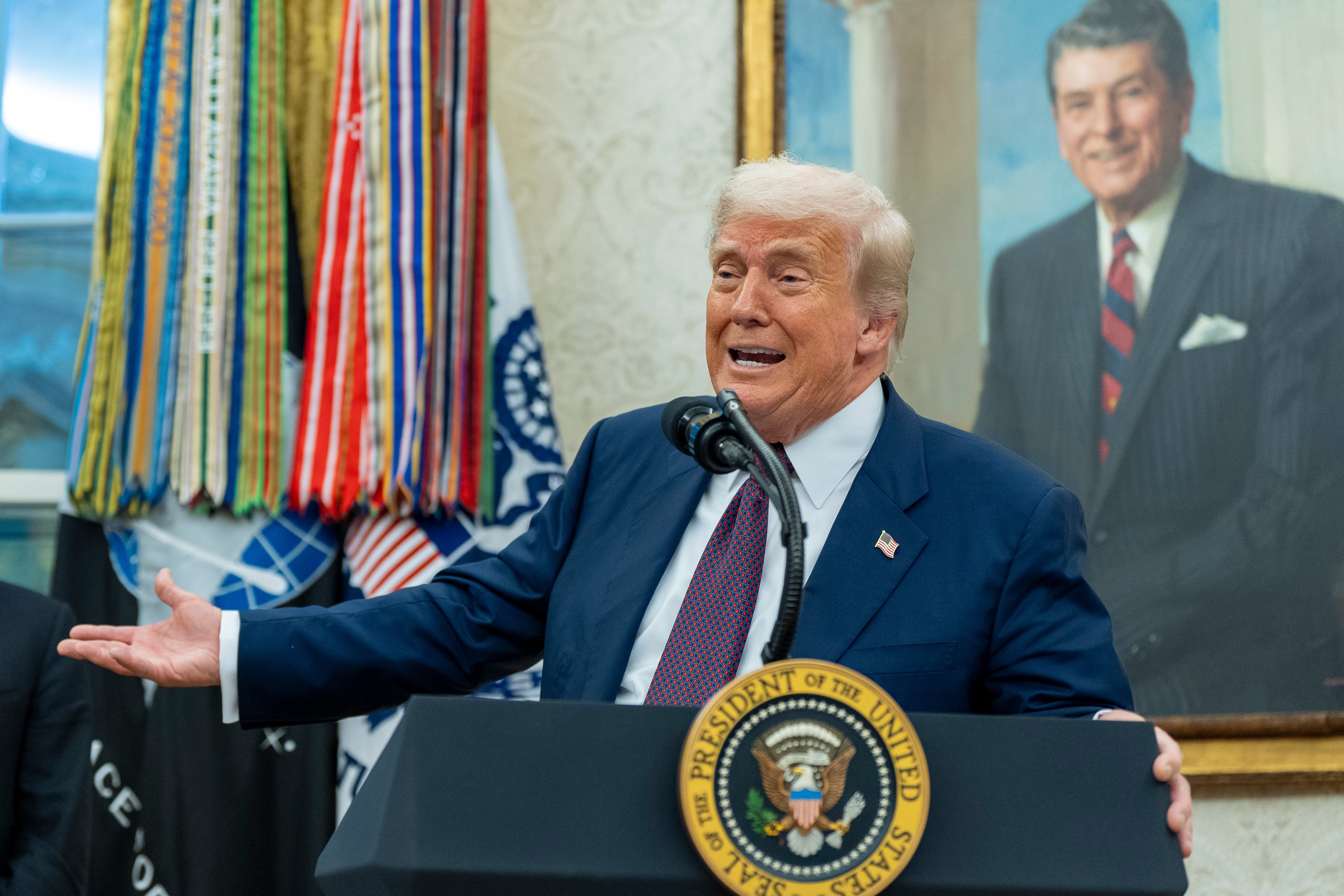 President Donald Trump speaks while making an announcement about Apple with Apple CEO Tim Cook in the Oval Office, Wednesday, Aug. 6, 2025