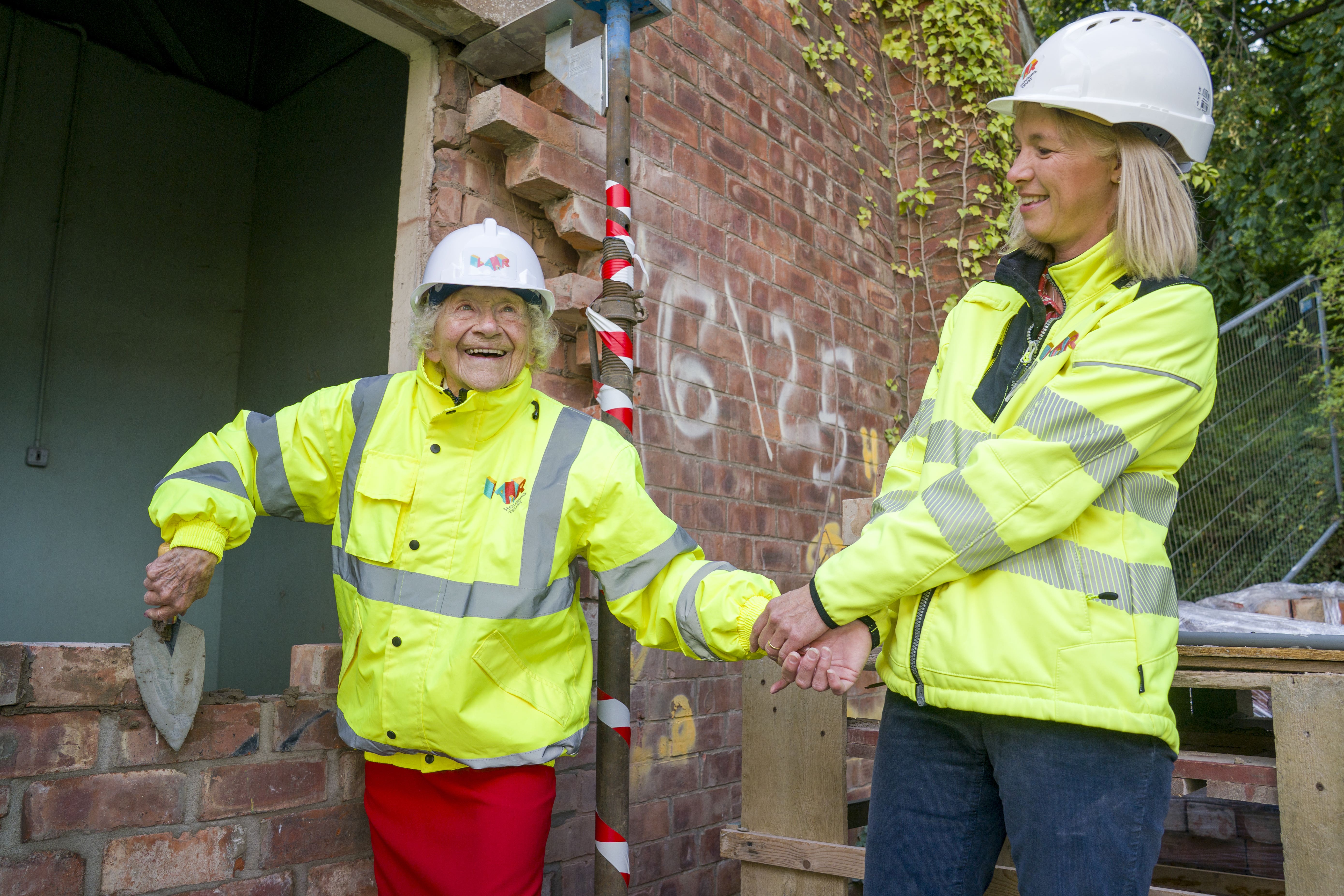 Dorothea Barron, 100, places the first brick at the new redevelopment (Jane Barlow/PA)