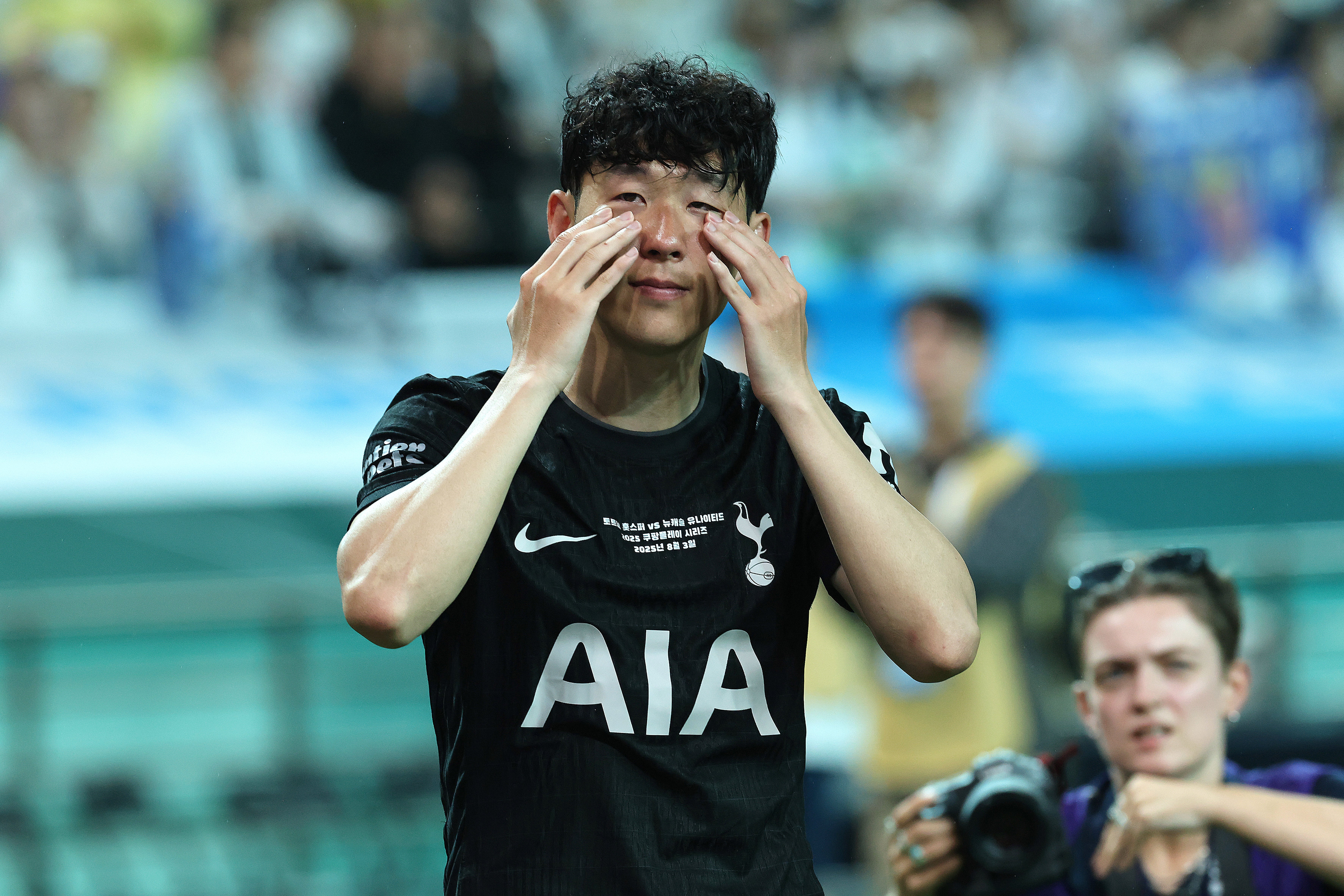 Son Heung-min wipes away his tears during his Tottenham farewell in pre-season