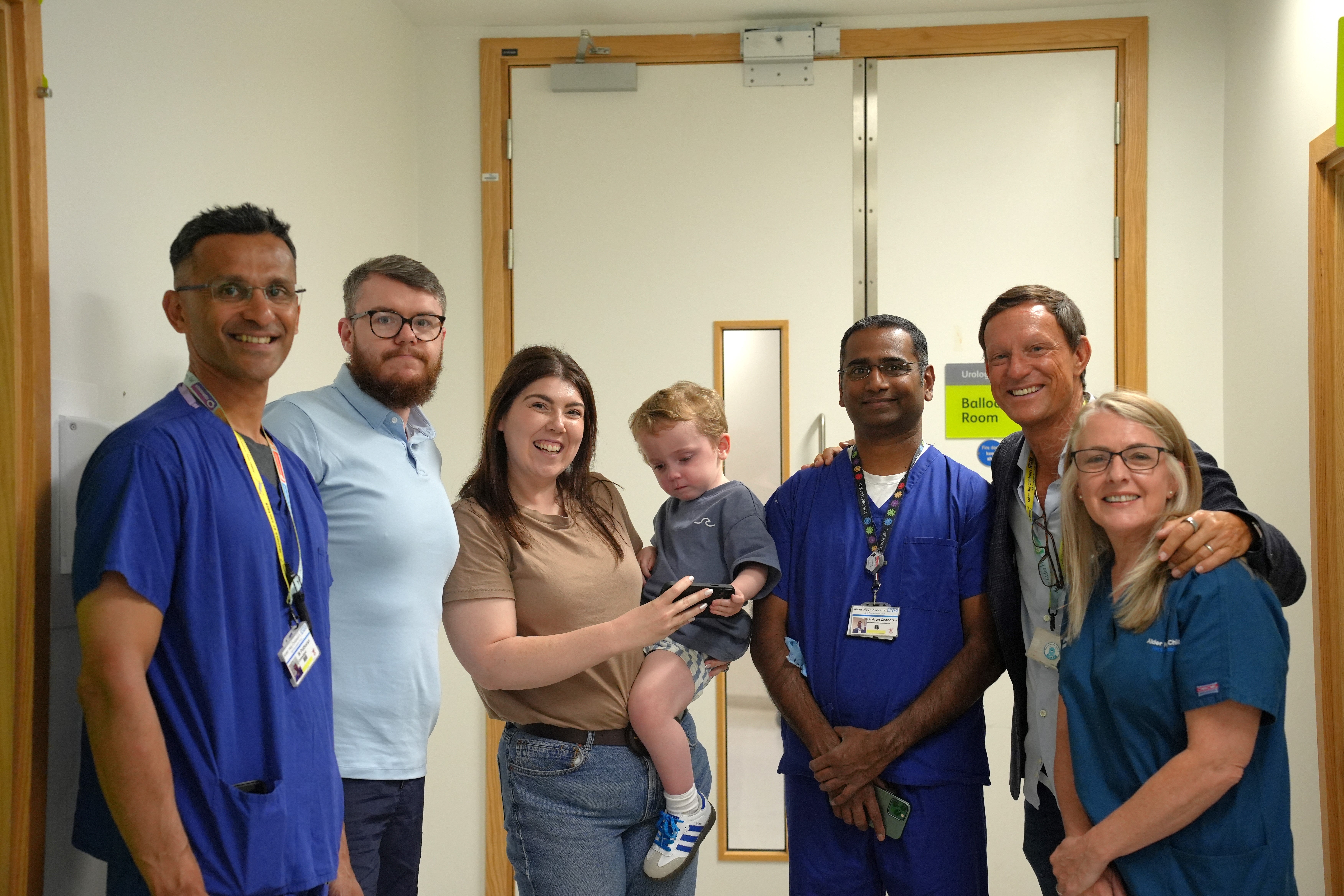 Lucy O'Rourke of herself (centre), holding her son Conor O'Rourke (centre), with some of the team at Alder Hey Children's Hospital in Liverpool who operated on Conor