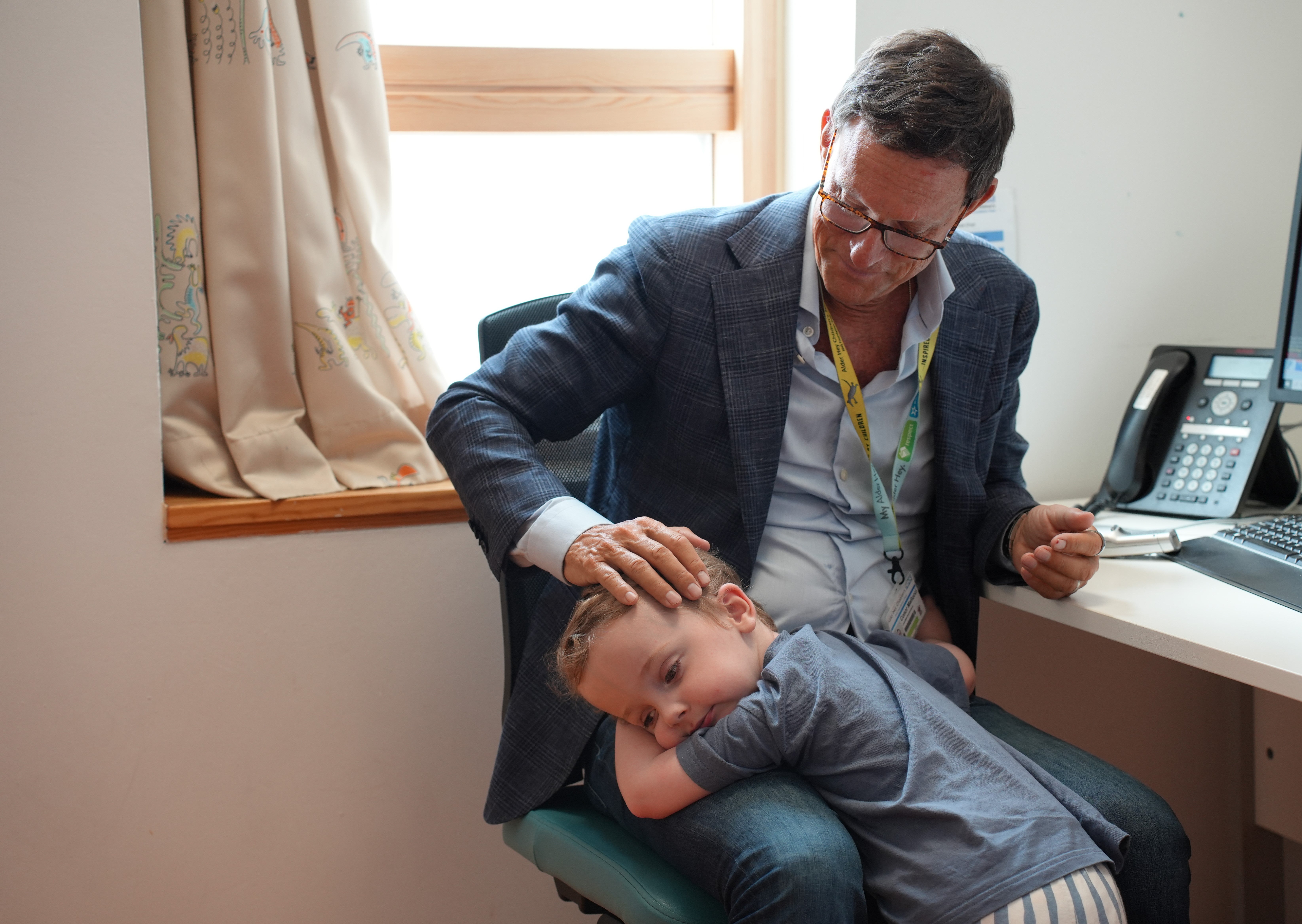 Conor O'Rourke, now three, from Bolton, hugging his surgeon Conor Mallucci, who helped operate him and save his life after he was diagnosed with an extremely rare birth defect known as vein of galen malformation (VOGM) in 2023