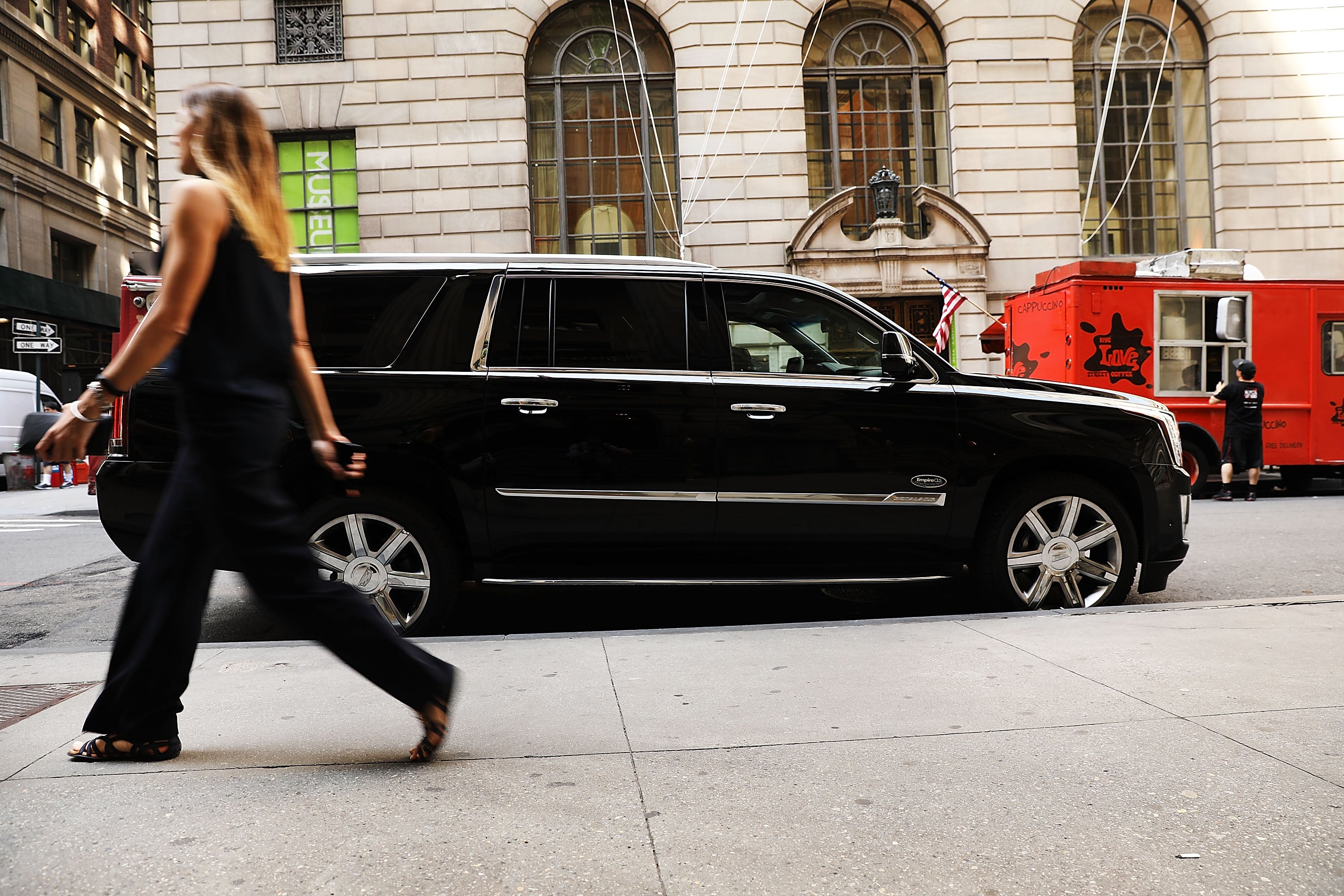 NEW YORK, NY - JUNE 14: A woman walks by a hired SUV as it waits for a client in Manhattan a day after it was announced that Uber co-founder Travis Kalanick will take a leave of absence as chief executive on June 14, 2017 in New York City. The move came after former attorney general Eric H. Holder Jr. and his law firm, Covington & Burling, released 13 pages of recommendations compiled as part of an investigation of sexual harassment at the ride-hailing car service. (Photo by Spencer Platt/Getty Images)