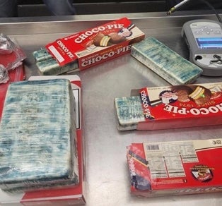 A man has been charged in a scheme to smuggle cocaine into New York disguised as packages of cigarettes and candy while working at the United States embassy in Dominican Republic, authorities say