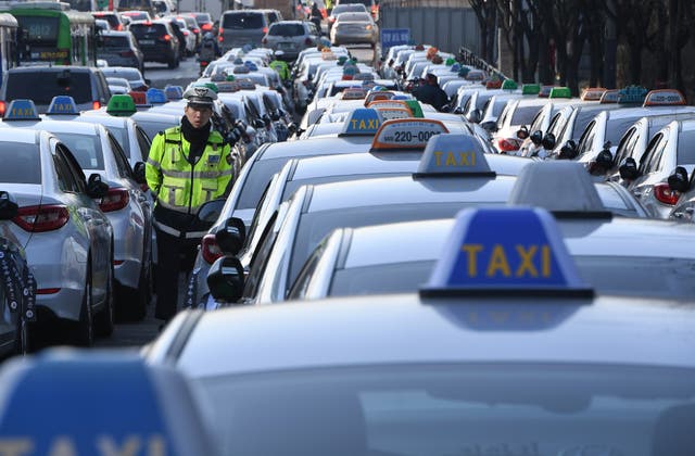<p>File. Policeman walks among South Korean taxis in 2018</p>