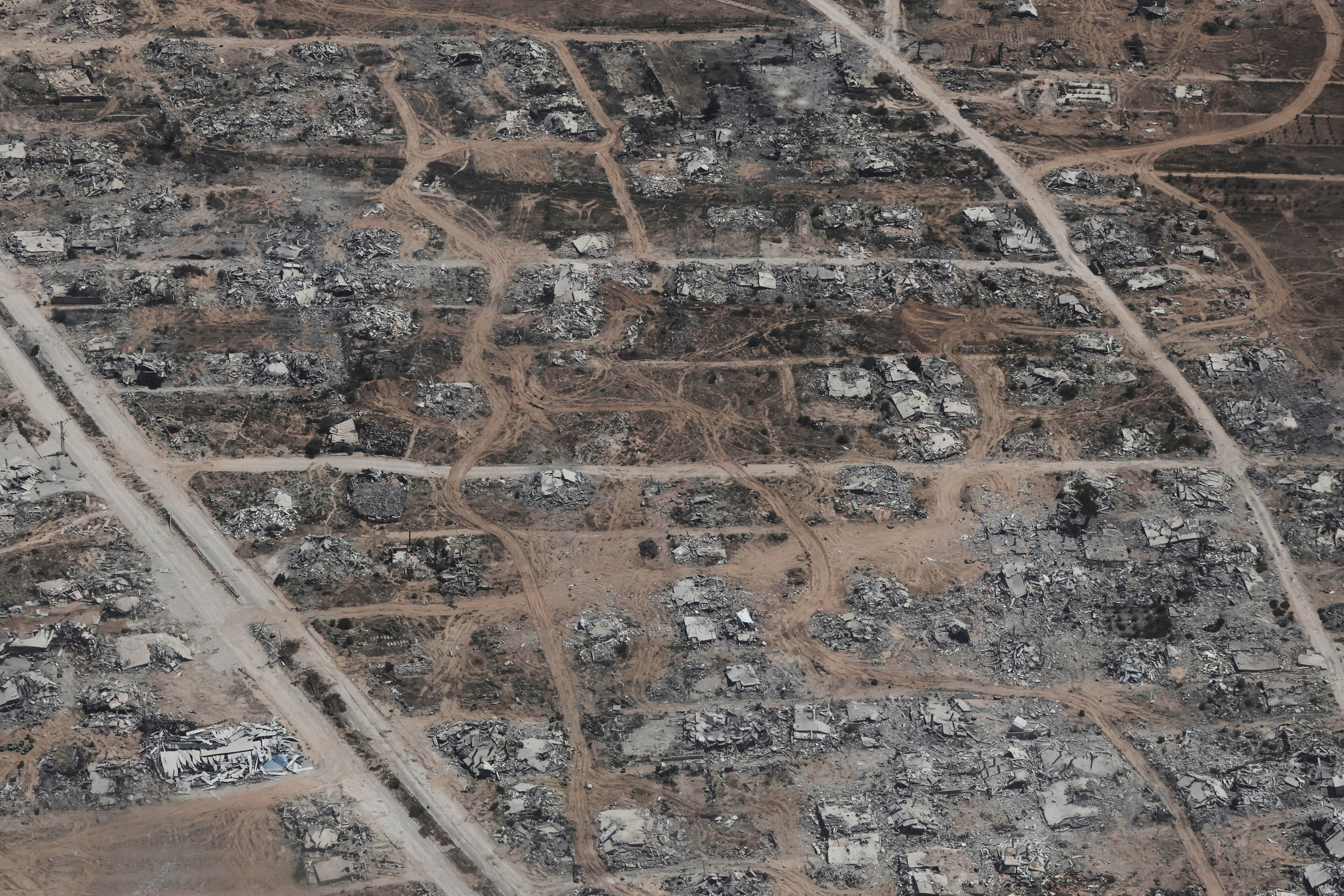 Destroyed buildings in the Gaza Strip are seen from a Jordanian Air Force C-130 plane during an airdrop of humanitarian aid for Palestinians, Thursday 7 August