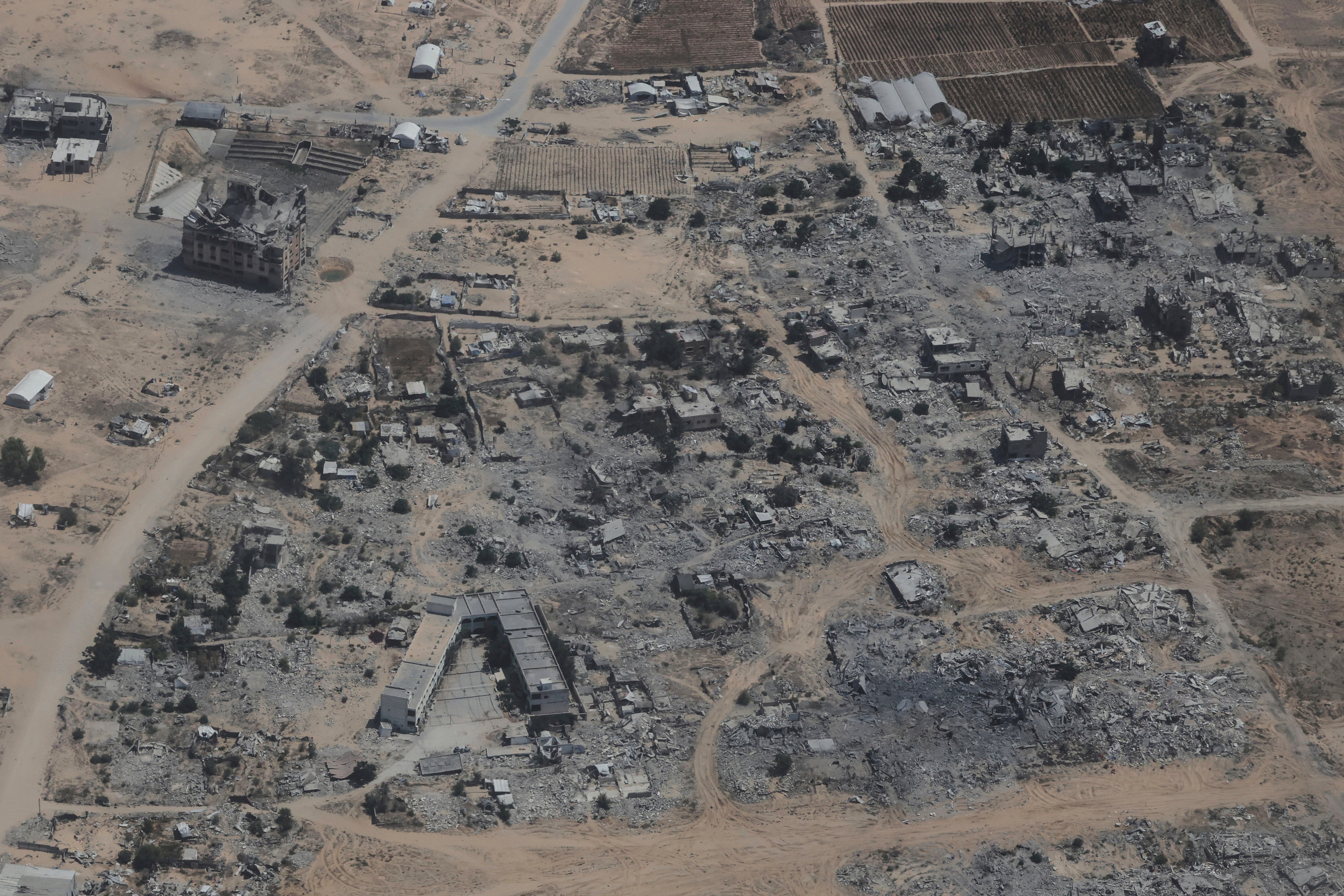Destroyed buildings in the Gaza Strip are seen from a Jordanian Air Force C-130 plane during an airdrop of humanitarian aid for Palestinians (Raad Adayleh/AP photo)