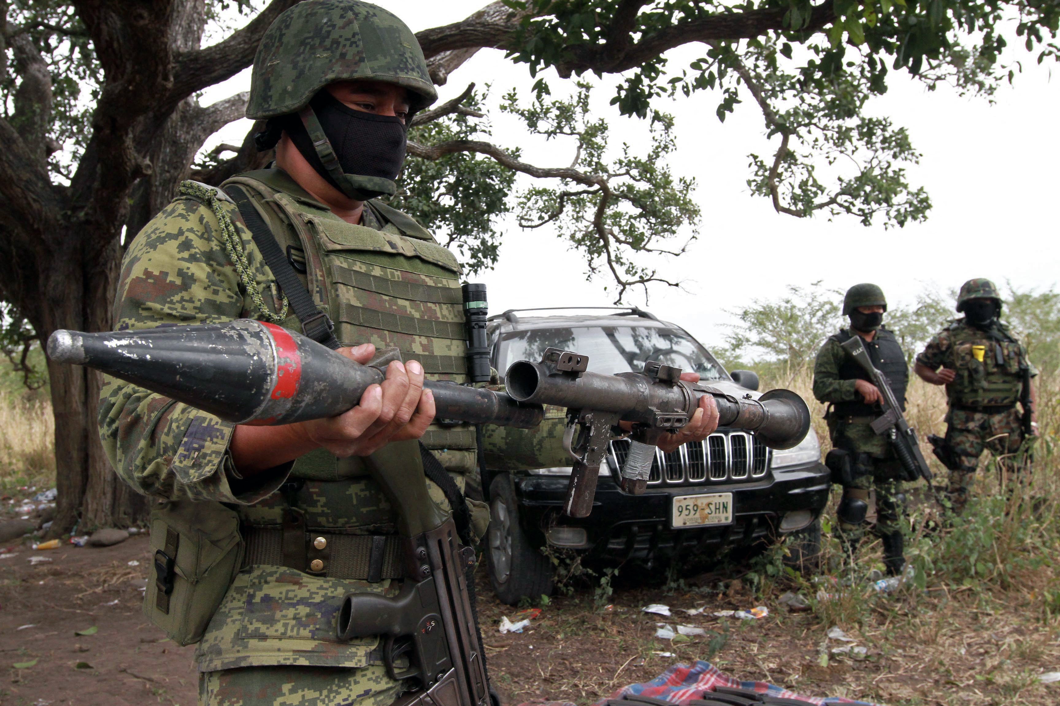 A Mexican Army soldier holds a rocket propeller grenade, RPG-7, part of an arsenal seized to alleged members of drug cartels. The use of American troops or naval forces against cartels or their members — persons who are civilians — could raise thorny legal issues