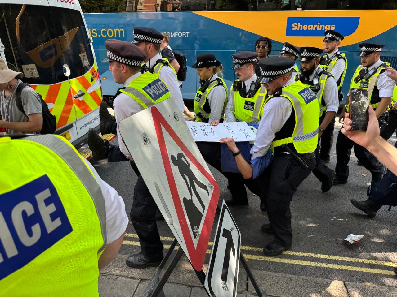 A protester is carried away by police officers