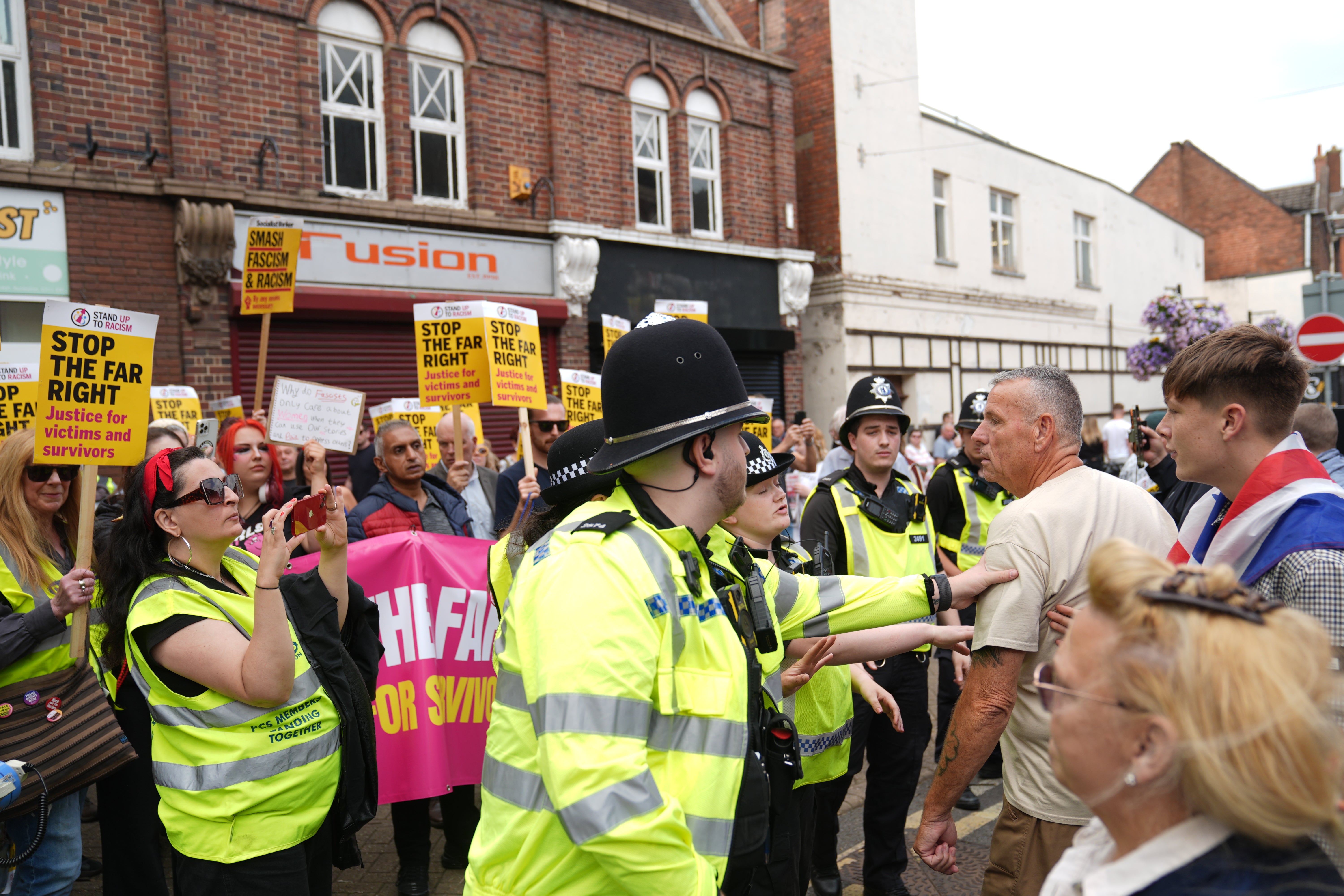 Police officers in between counter protesters and an anti-immigration protest in Nuneaton