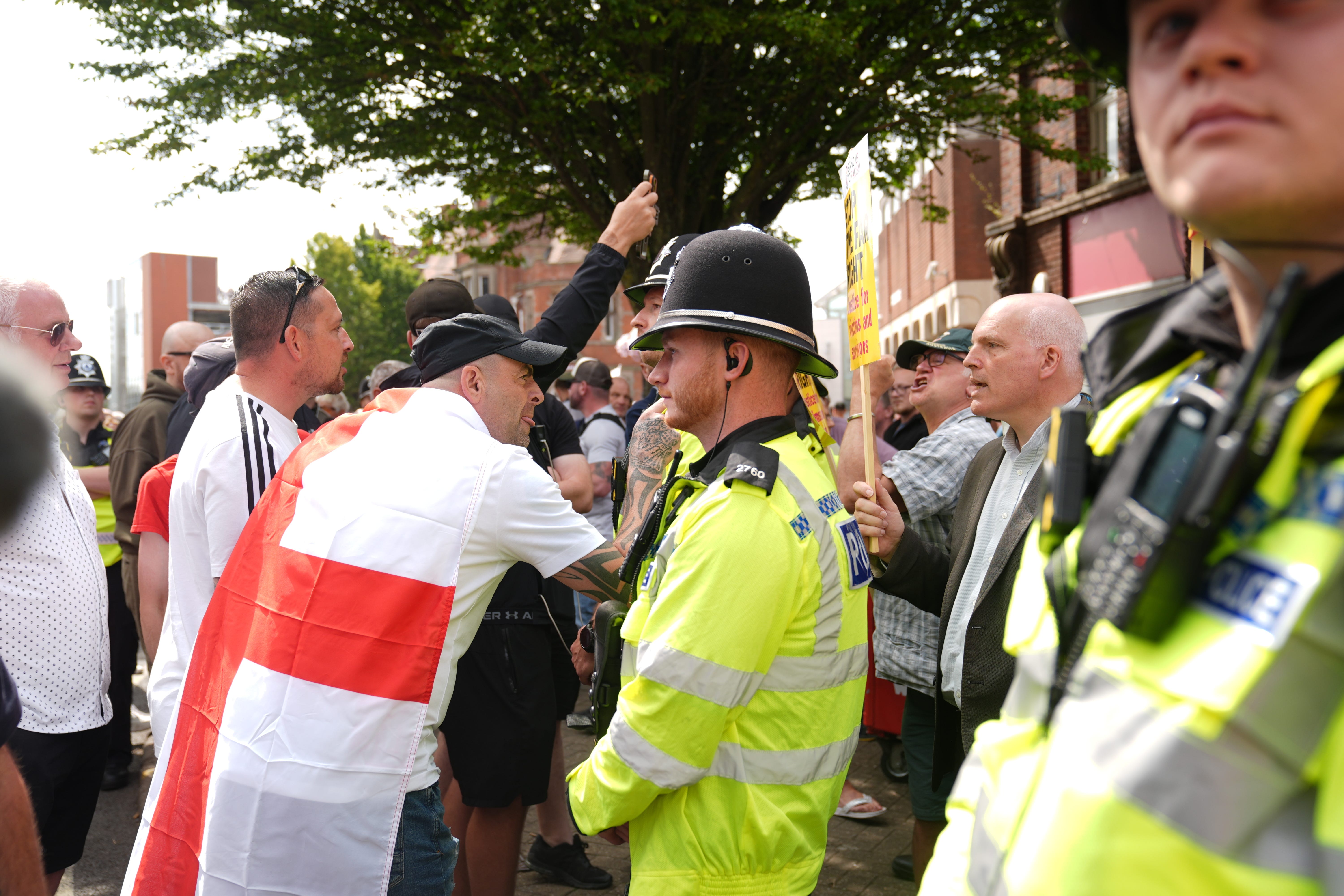 Police officers in between counter-protesters and an anti-immigration protest outside Nuneaton and Bedworth Borough Council (Joe Giddens/PA)