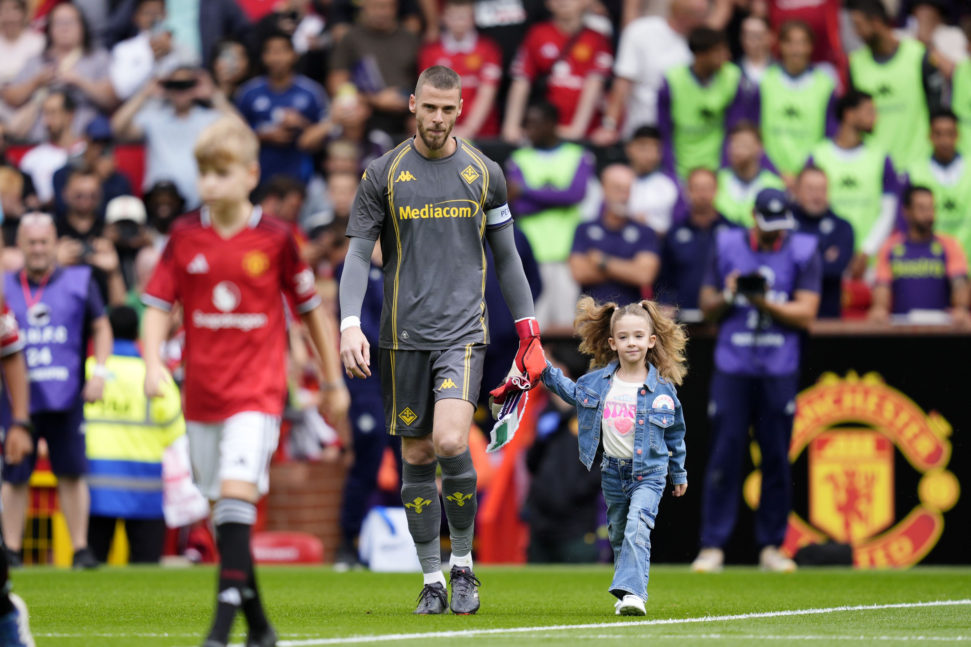 Fiorentina goalkeeper David De Gea walks out at Old Trafford with his daughter (Nick Potts/PA).