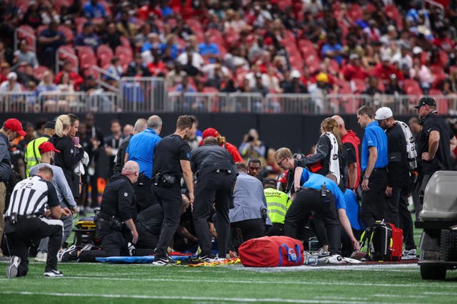 <p>Medical personnel treating Morice Norris on the field</p>