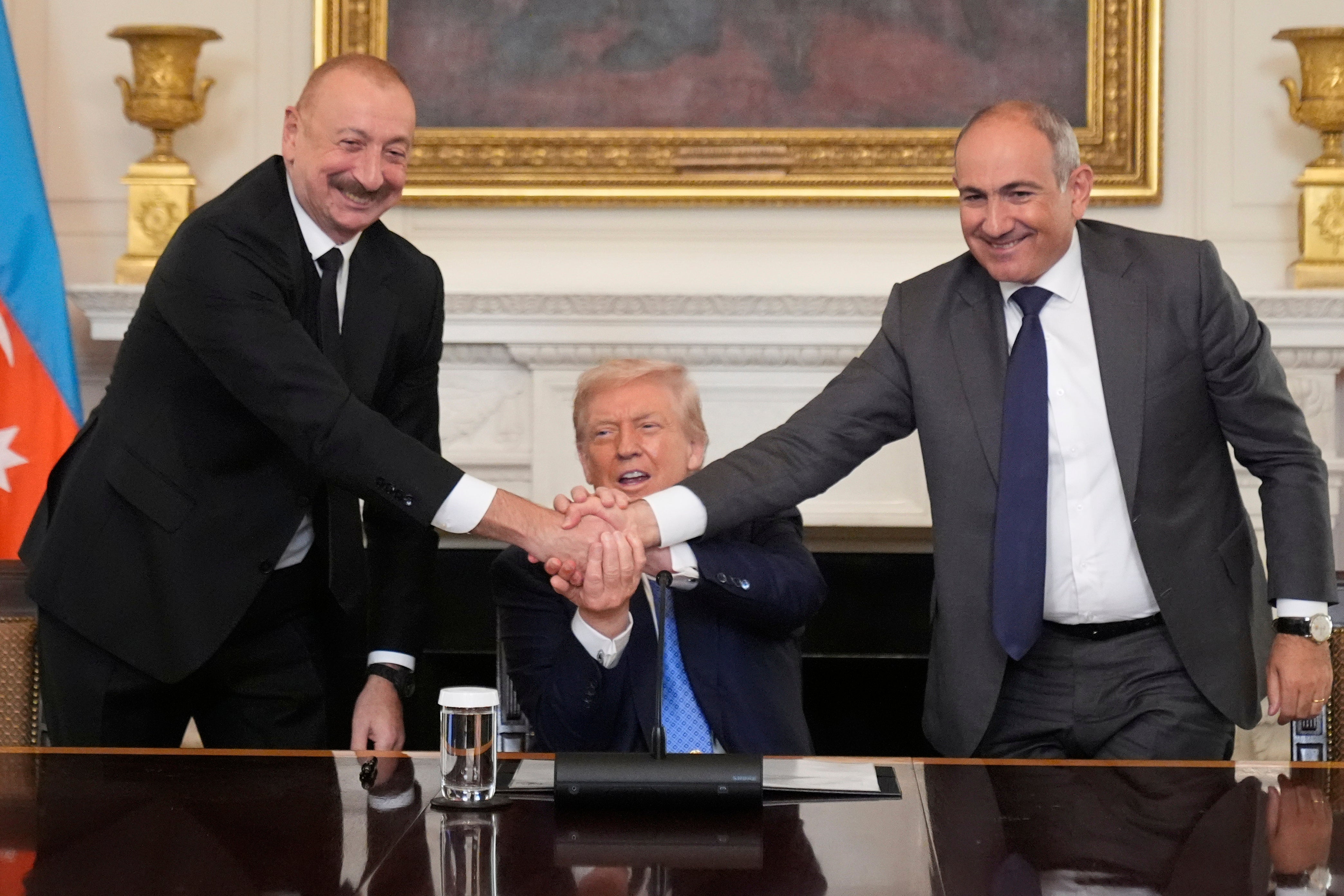 Azerbaijan's President Ilham Aliyev (left) and Armenian Prime Minister Nikol Pashinyan (right) shook hands after Trump described the event as ‘historic’