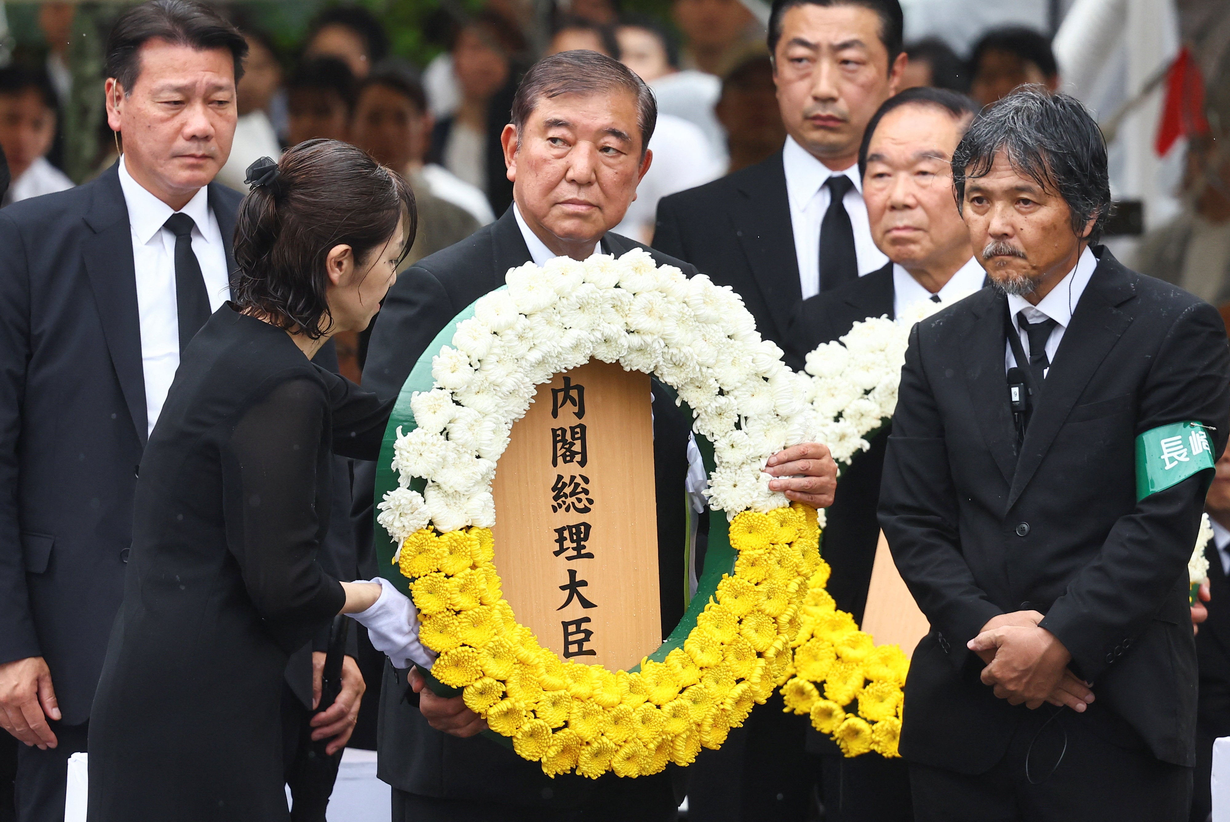 Japan's Prime Minister Shigeru Ishiba offers a flower wreath for the victims of the 1945 atomic bombing