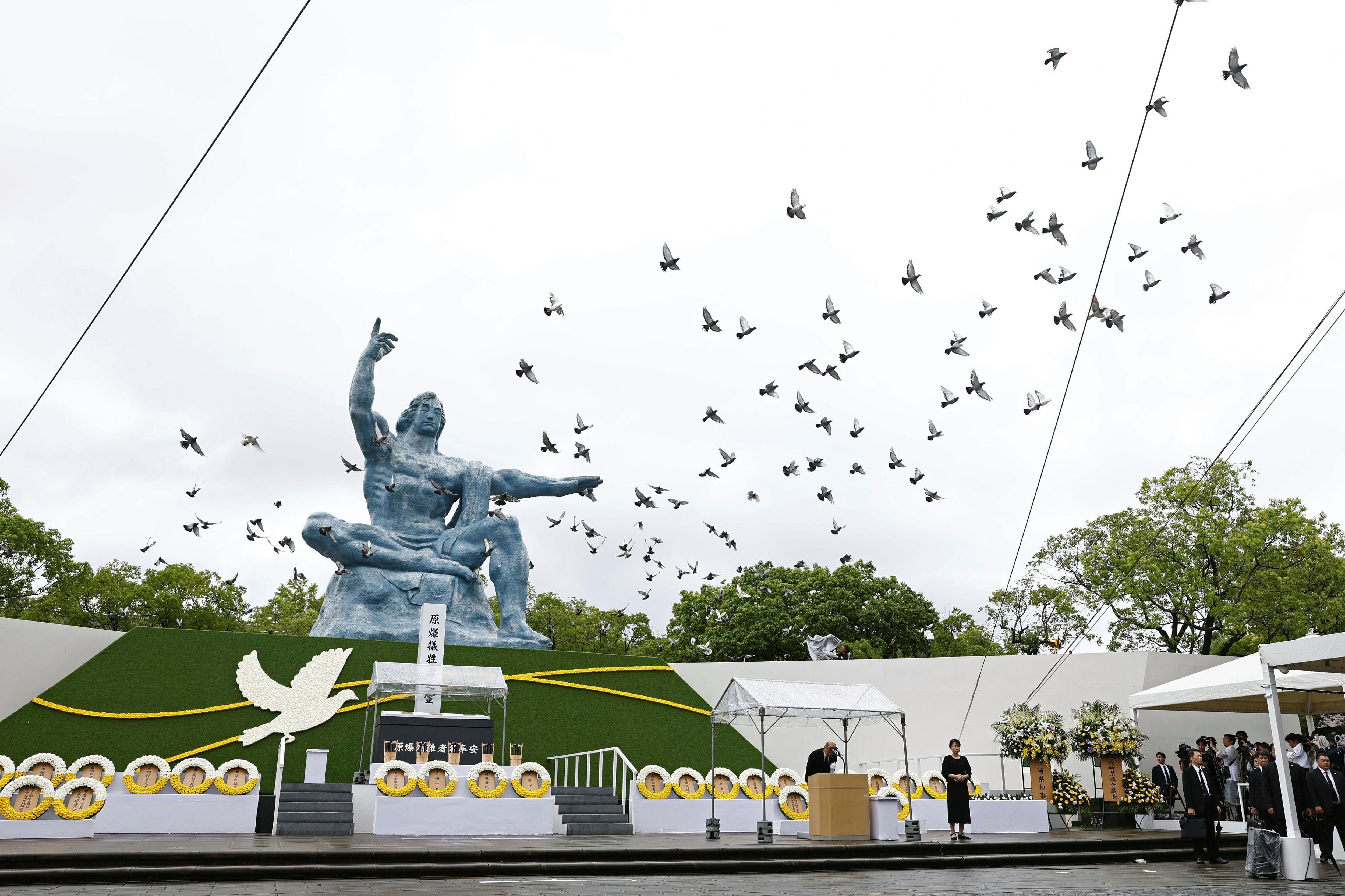 Doves are released over the Peace Statue during a ceremony to mark the 80th anniversary of the US atomic bombing at the Peace Park in Nagasaki