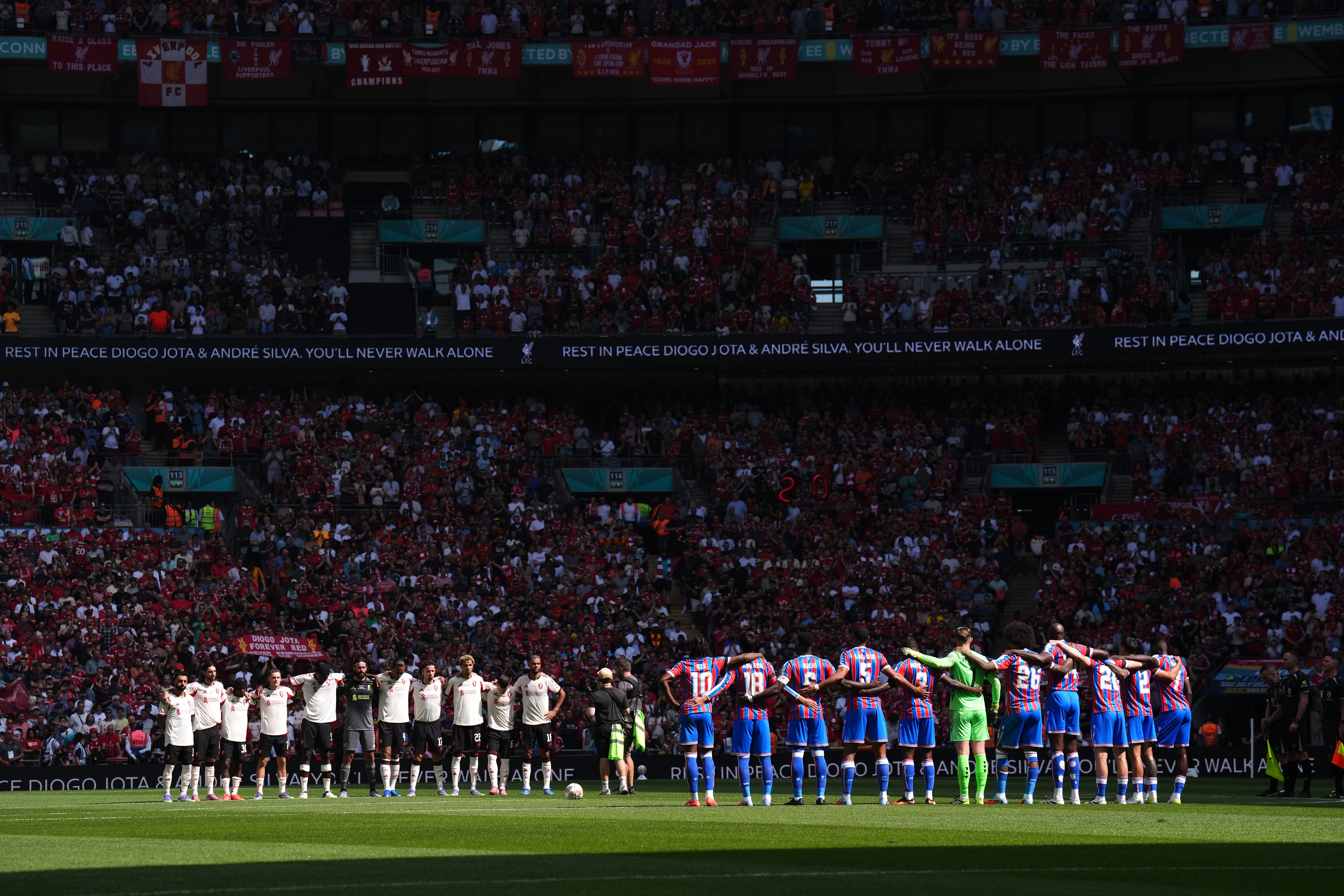 Liverpool and Crystal Palace stand during a minute’s silence (John Walton/PA)