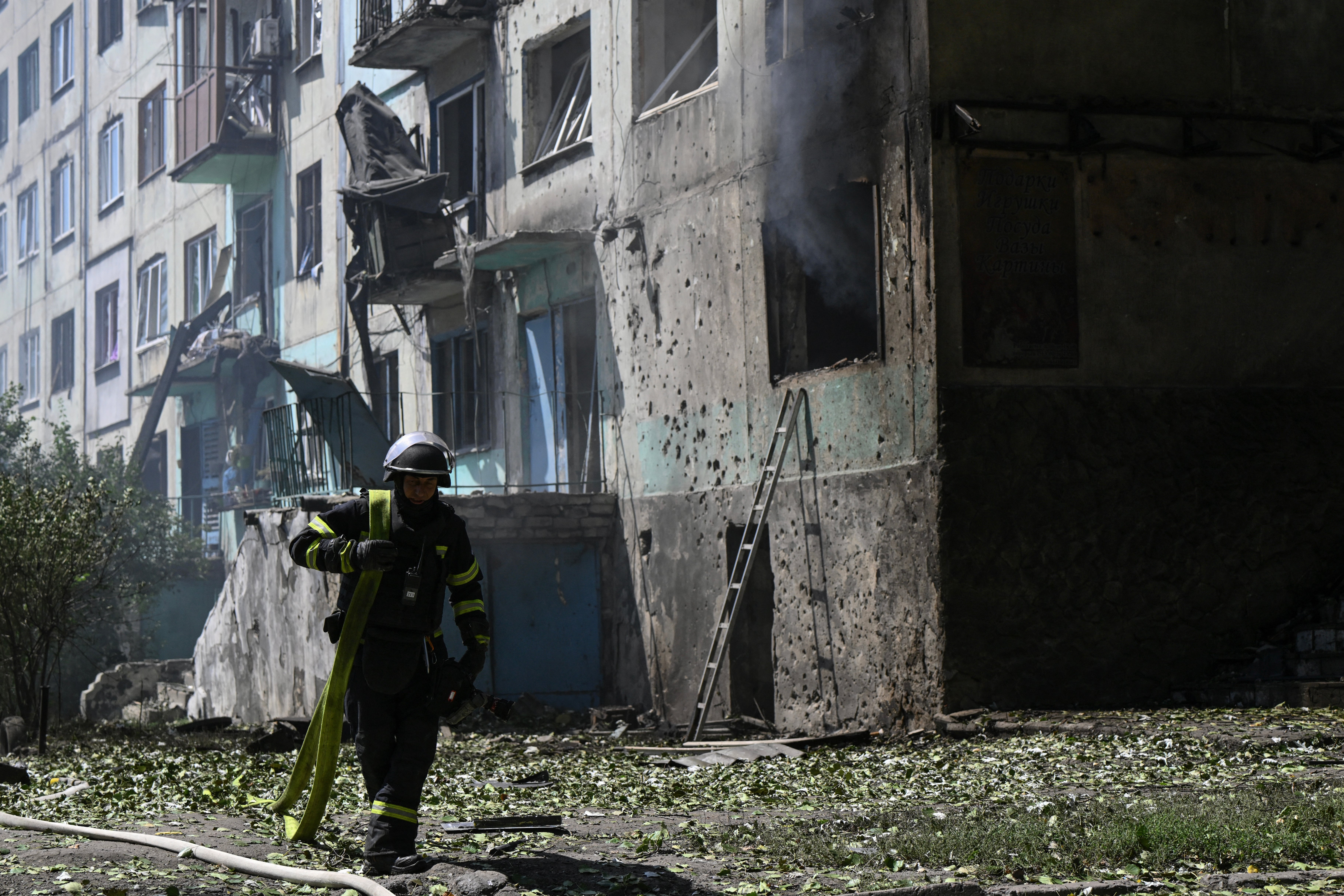 A firefighter at the site of a Russian drone strike in the town of Bilozerske in the Donetsk region on Sunday