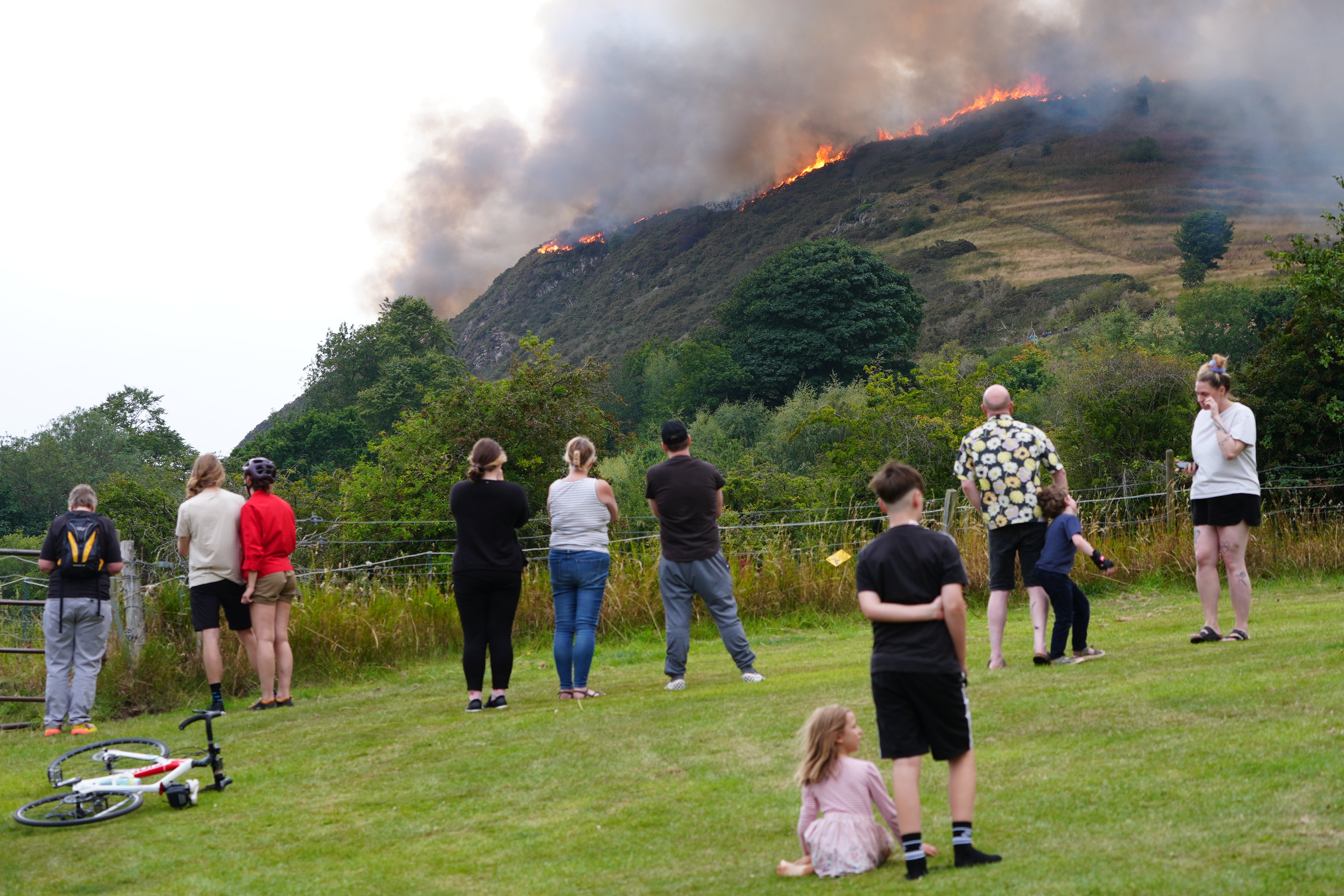 Members of the public watch the fire on Arthur’s Seat in Holyrood Park, Edinburgh (Jane Barlow/PA)