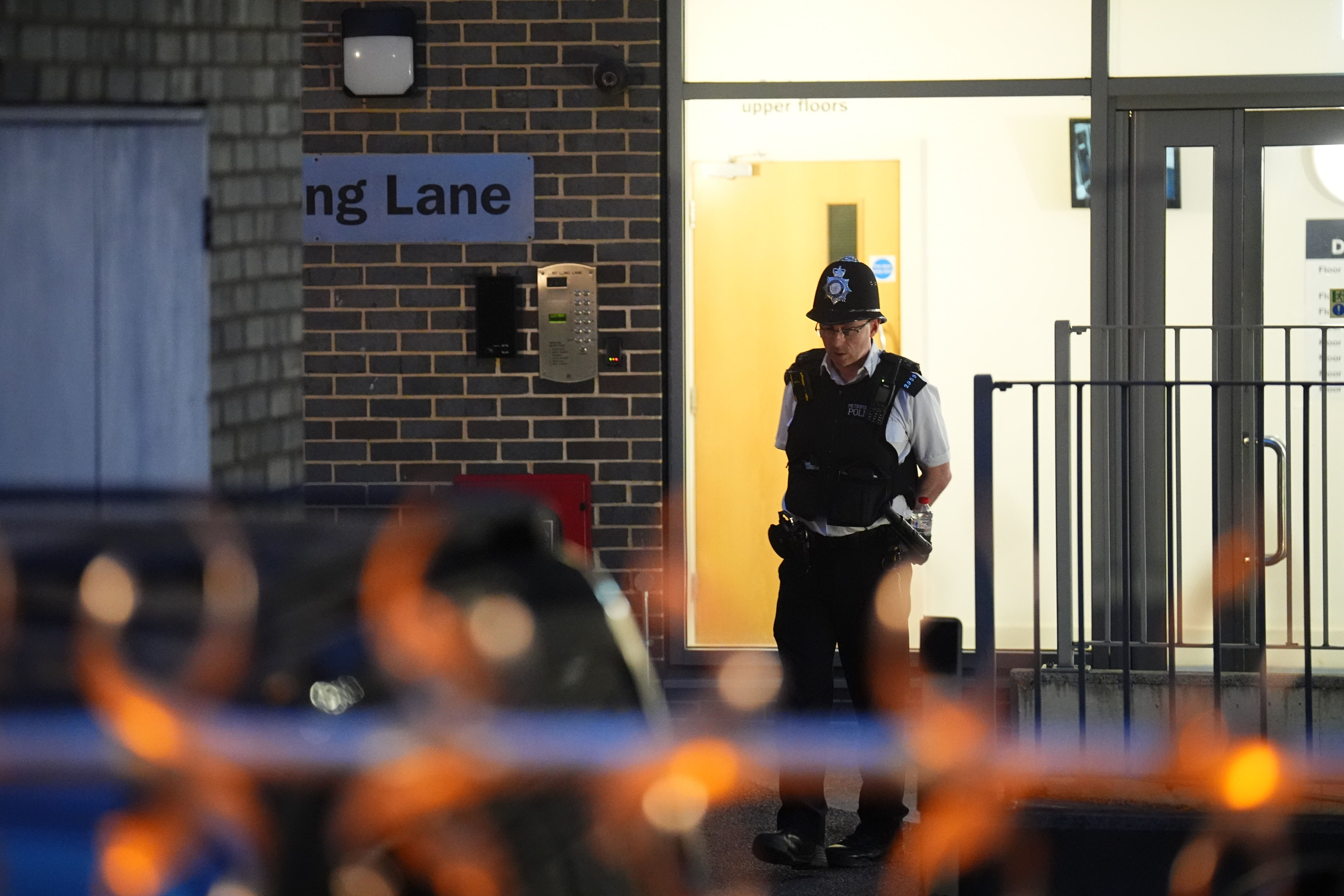Police officers at the scene in Long Lane, Southwark (James Manning/PA)