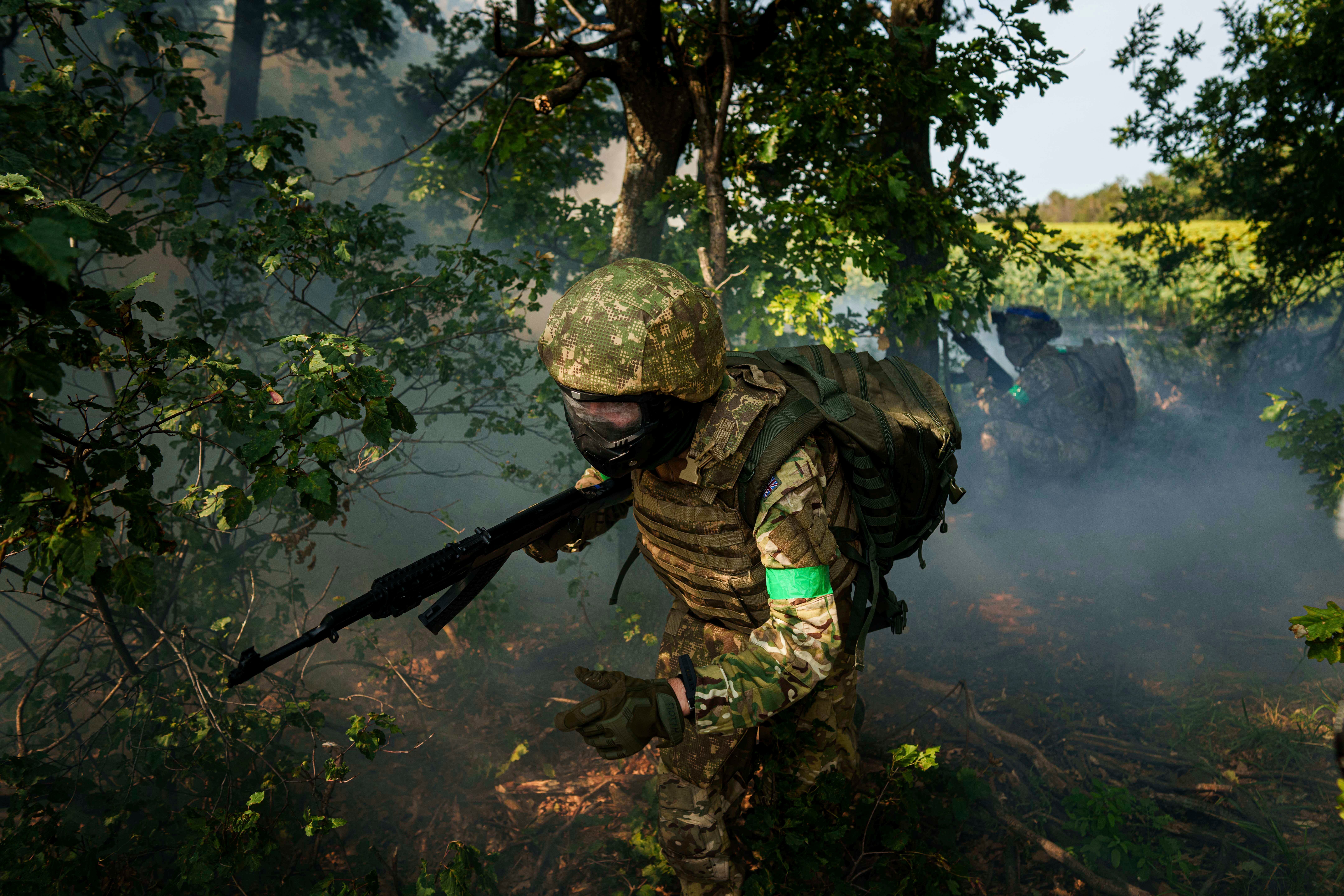 A Ukrainian National Guard serviceman of 3rd brigade «Spartan» runs through a tree line during a training not far from the frontline on Pokrovsk direction, Ukraine, on Friday, August 8, 2025. (AP Photo/Evgeniy Maloletka)