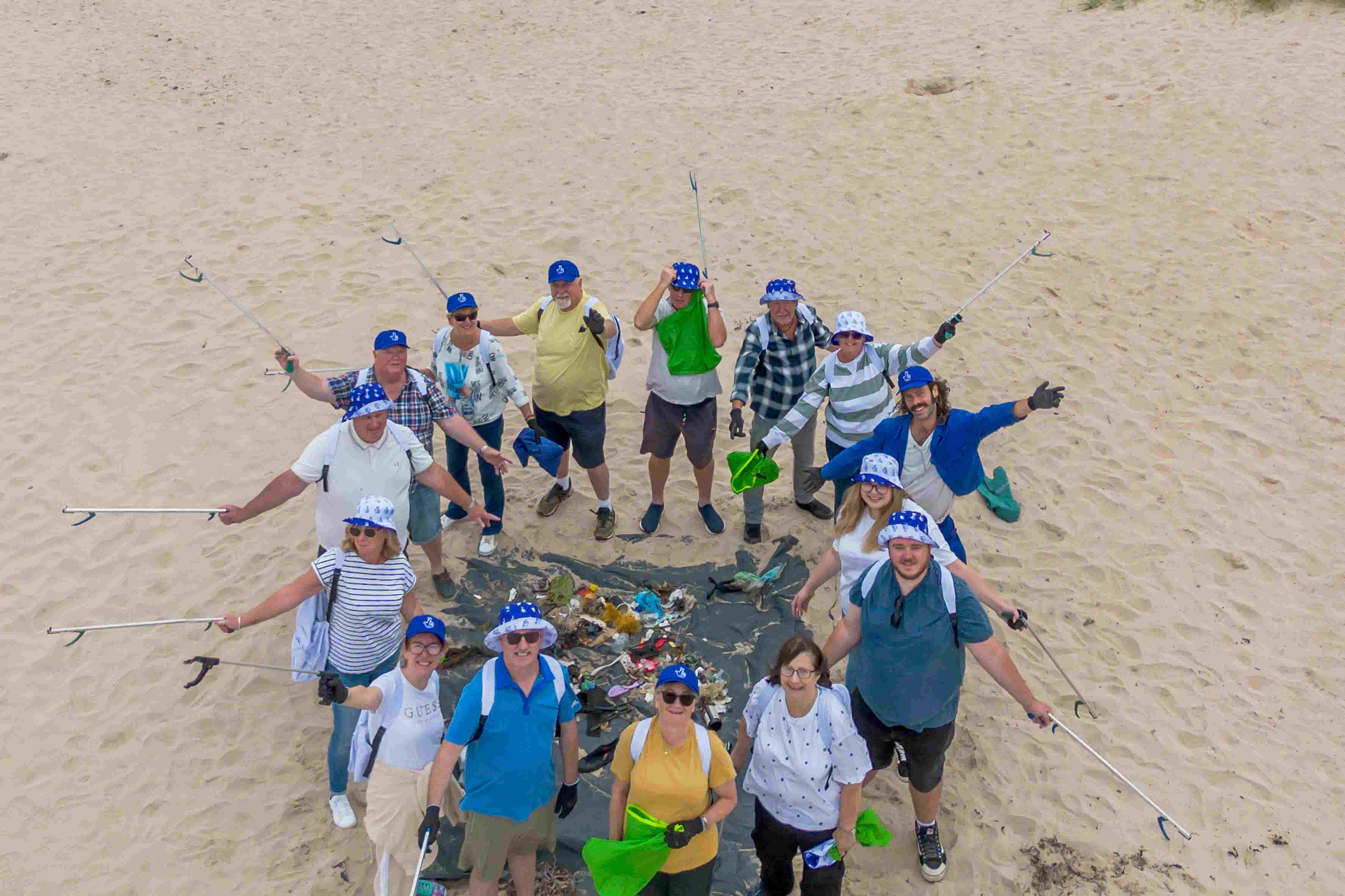 National Lottery winners joined together to help clean up at popular Bamburgh beach in Northumberland (Anthony Devlin/National Lottery/PA)