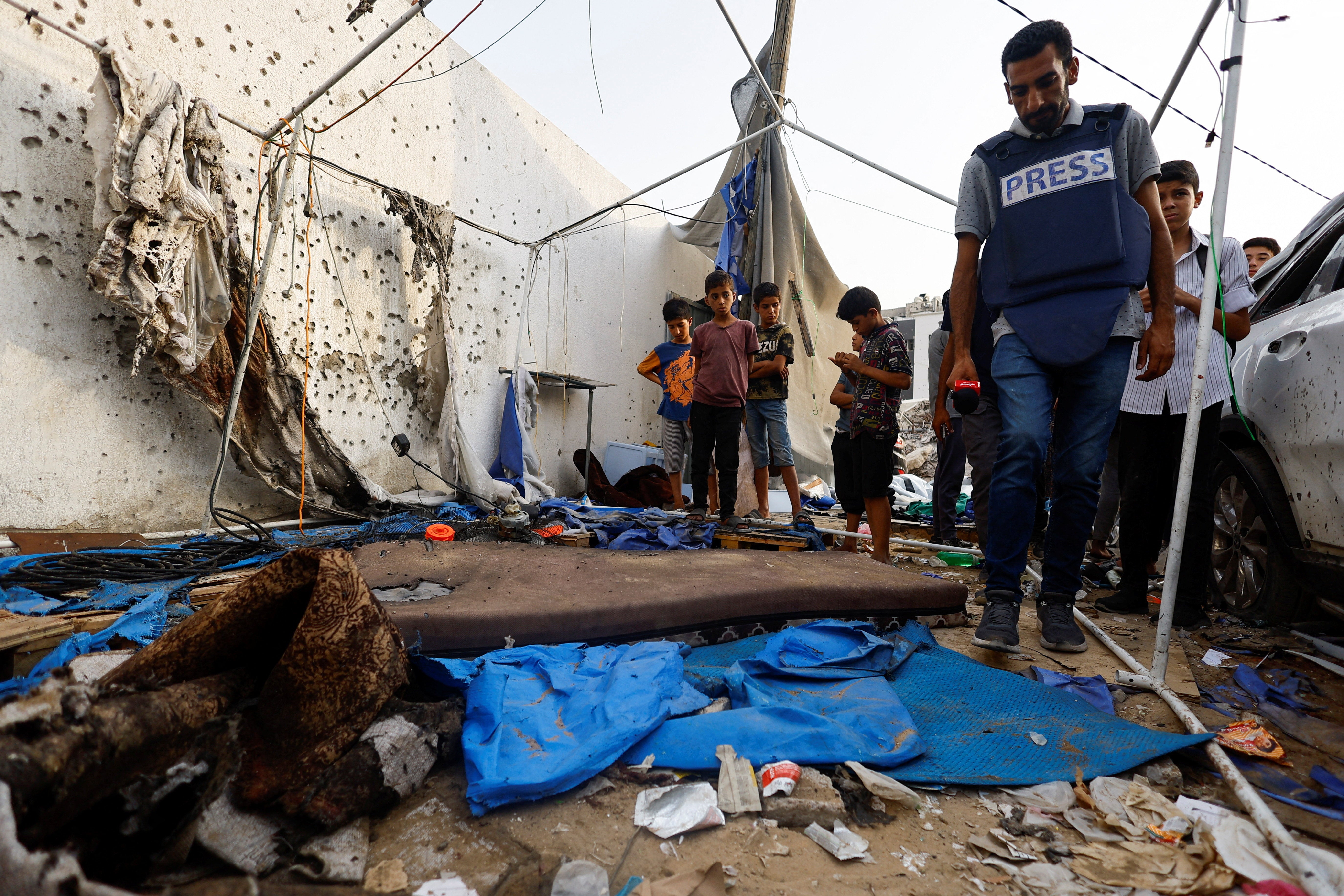 A member of the media inspects the site of an Israeli strike on a tent near Shifa Hospital yesterday
