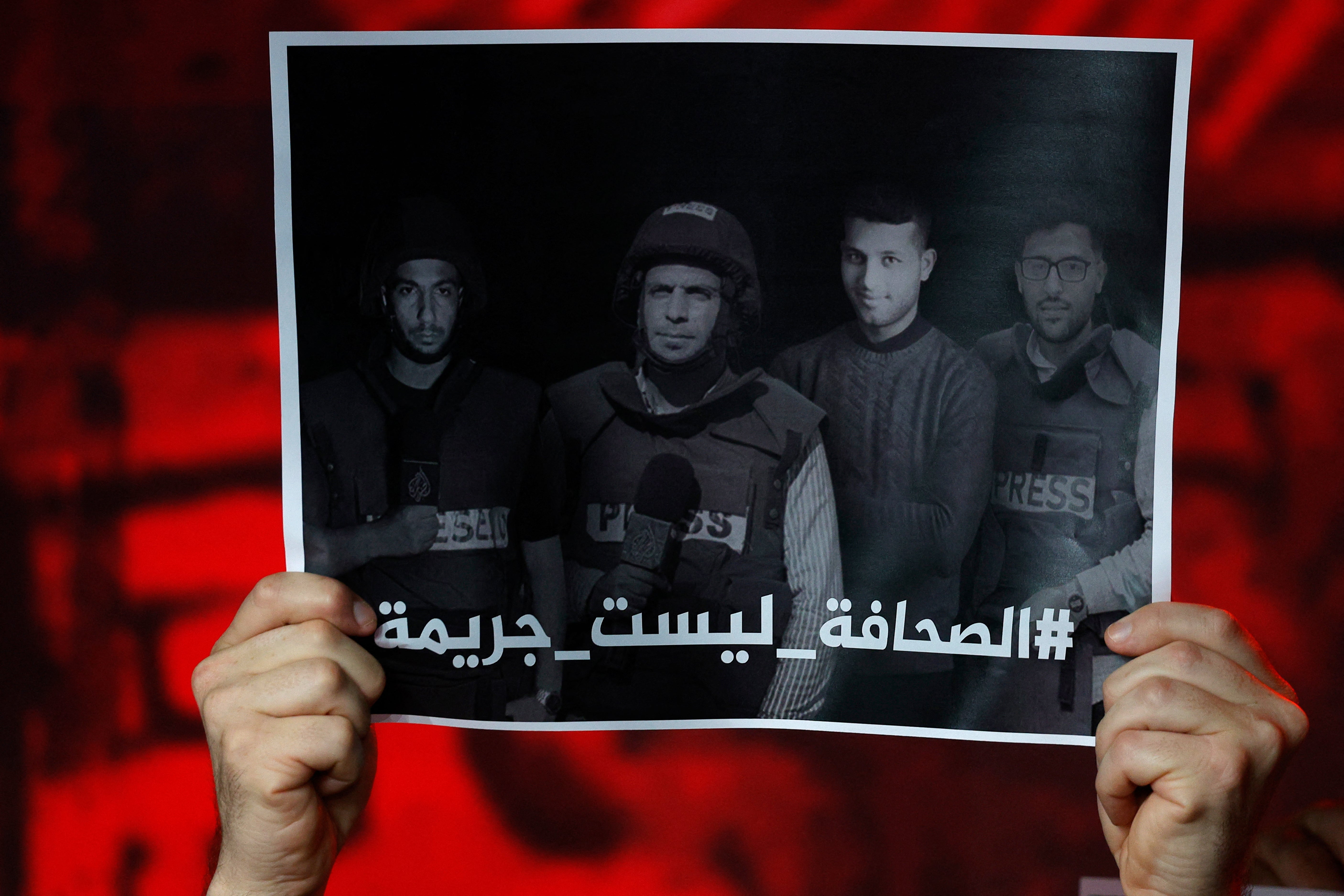 Al Jazeera staff members observe a moment of silence to honour their five colleagues killed by Israeli forces in Gaza City