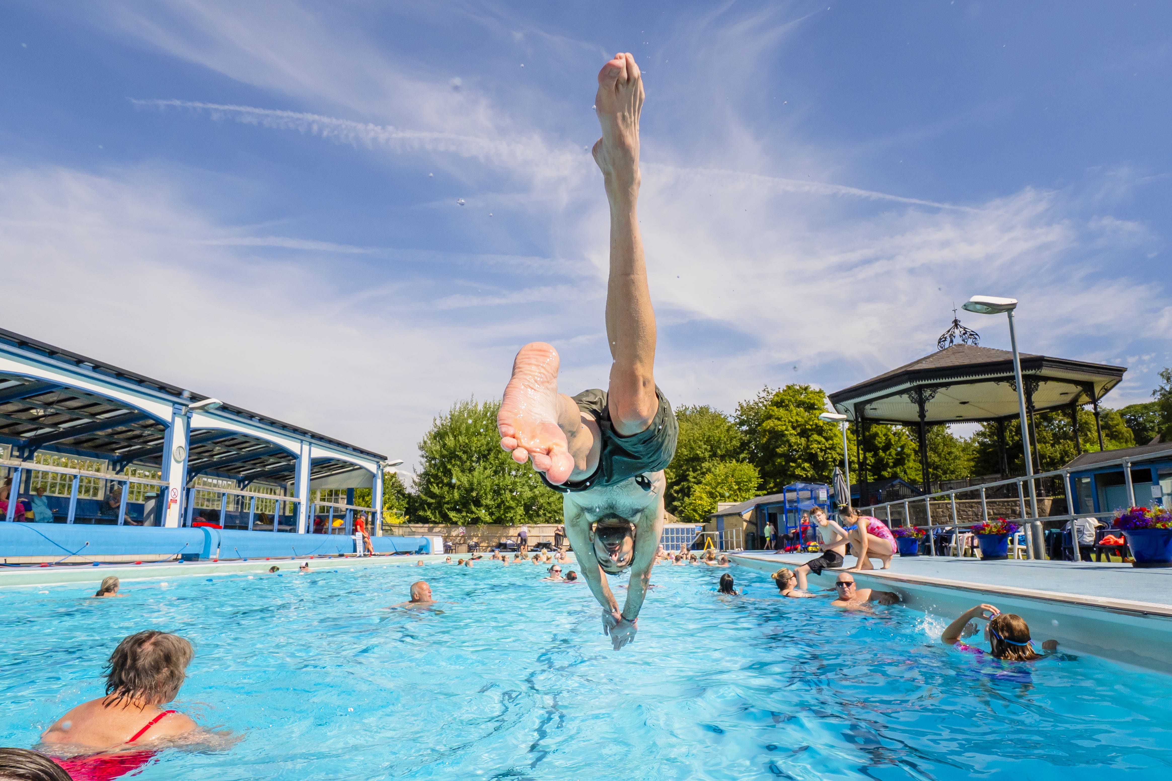 A man dives into Hathersage open-air swimming pool, at Hope Valley in the Peak District (Danny Lawson/PA)