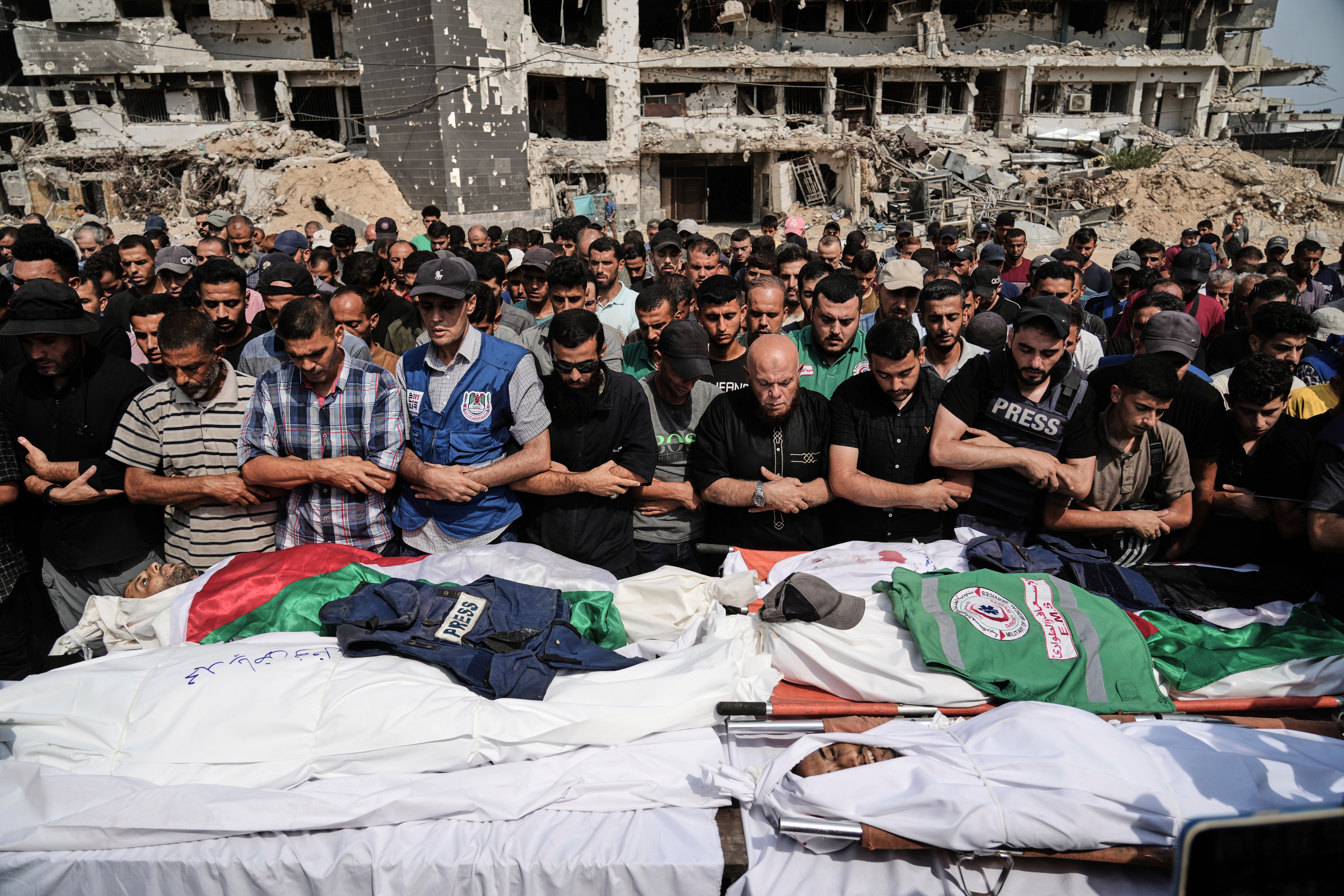 Palestinians pray over the bodies of journalists, including Anas al-Sharif, who were killed by Israeli forces in Gaza