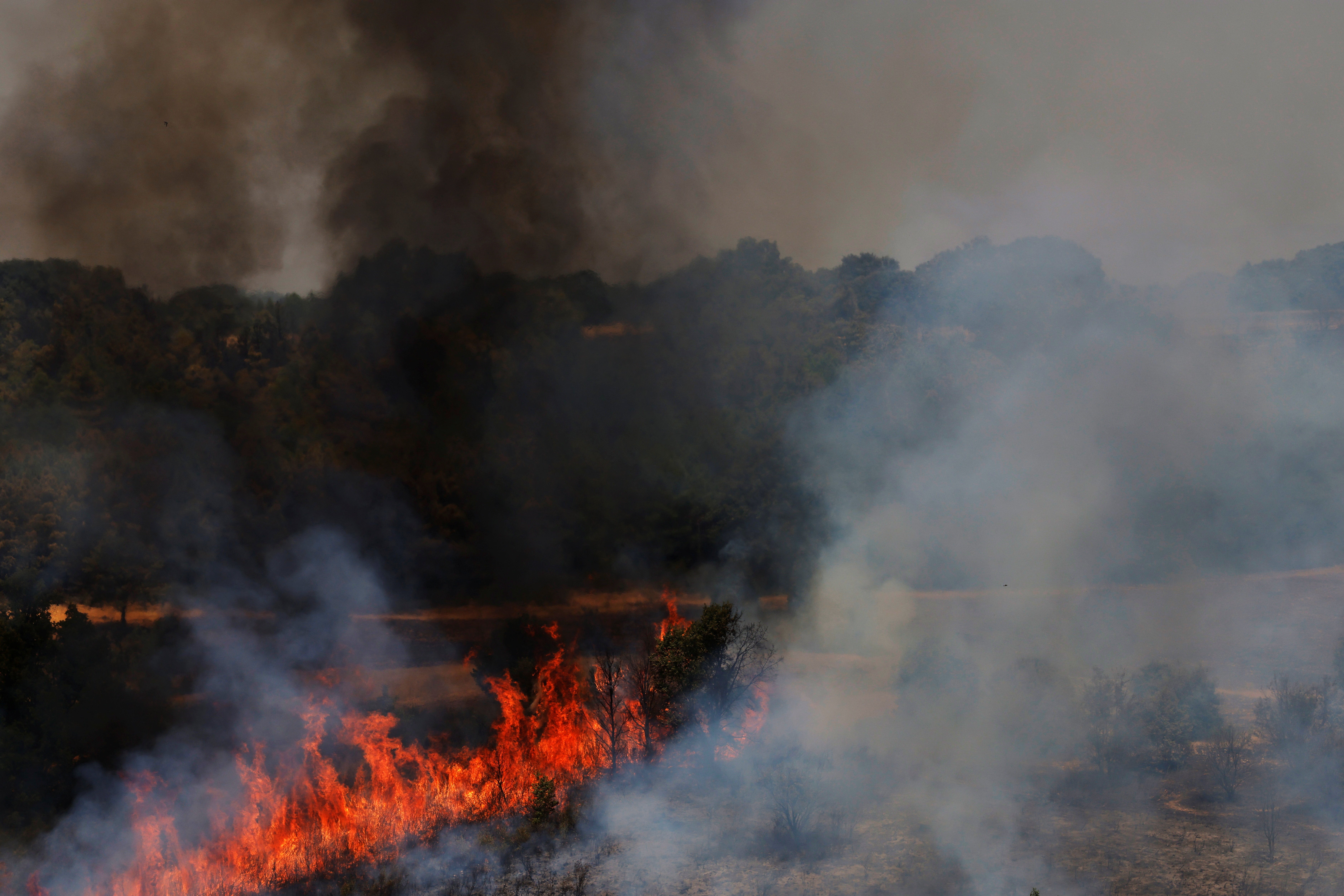 Wildfires continued to burn in Congosta, in the Castile and Leon region, on Monday